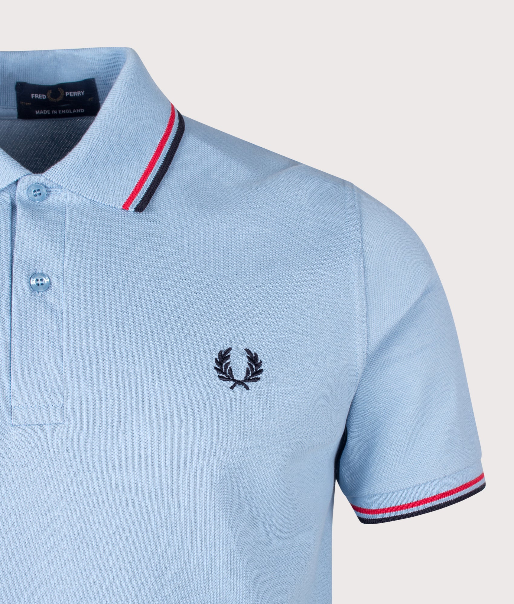 Fred Perry M12 Twin Tipped Fred Perry Polo Shirt in Sky, Red and Navy at EQVVS Menswear. Detail shot.