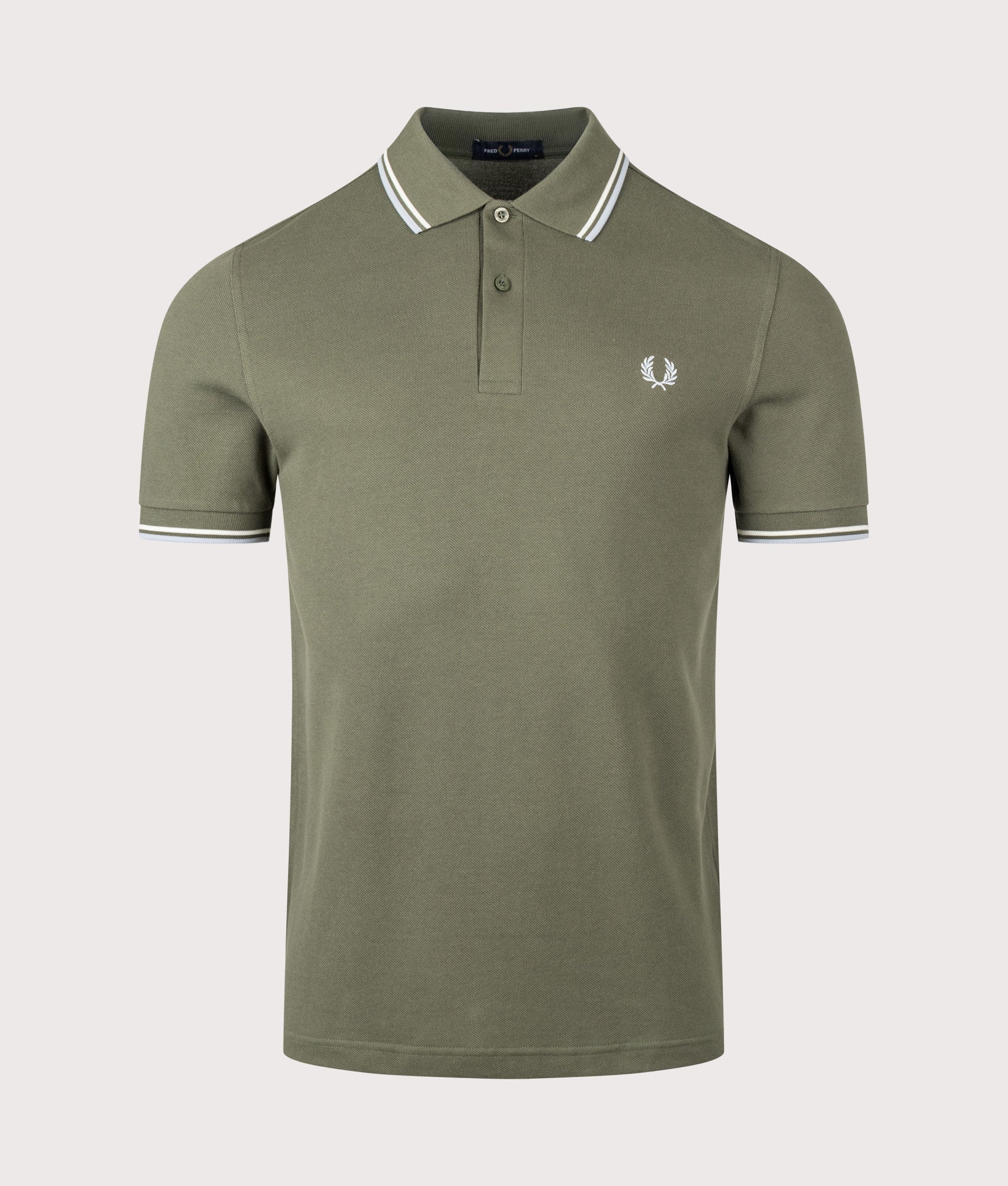Fred Perry Twin Tipped Polo Shirt in Laurel Wreath Green, Ecru and Dusky Blue at EQVVS Menswear. Front shot.