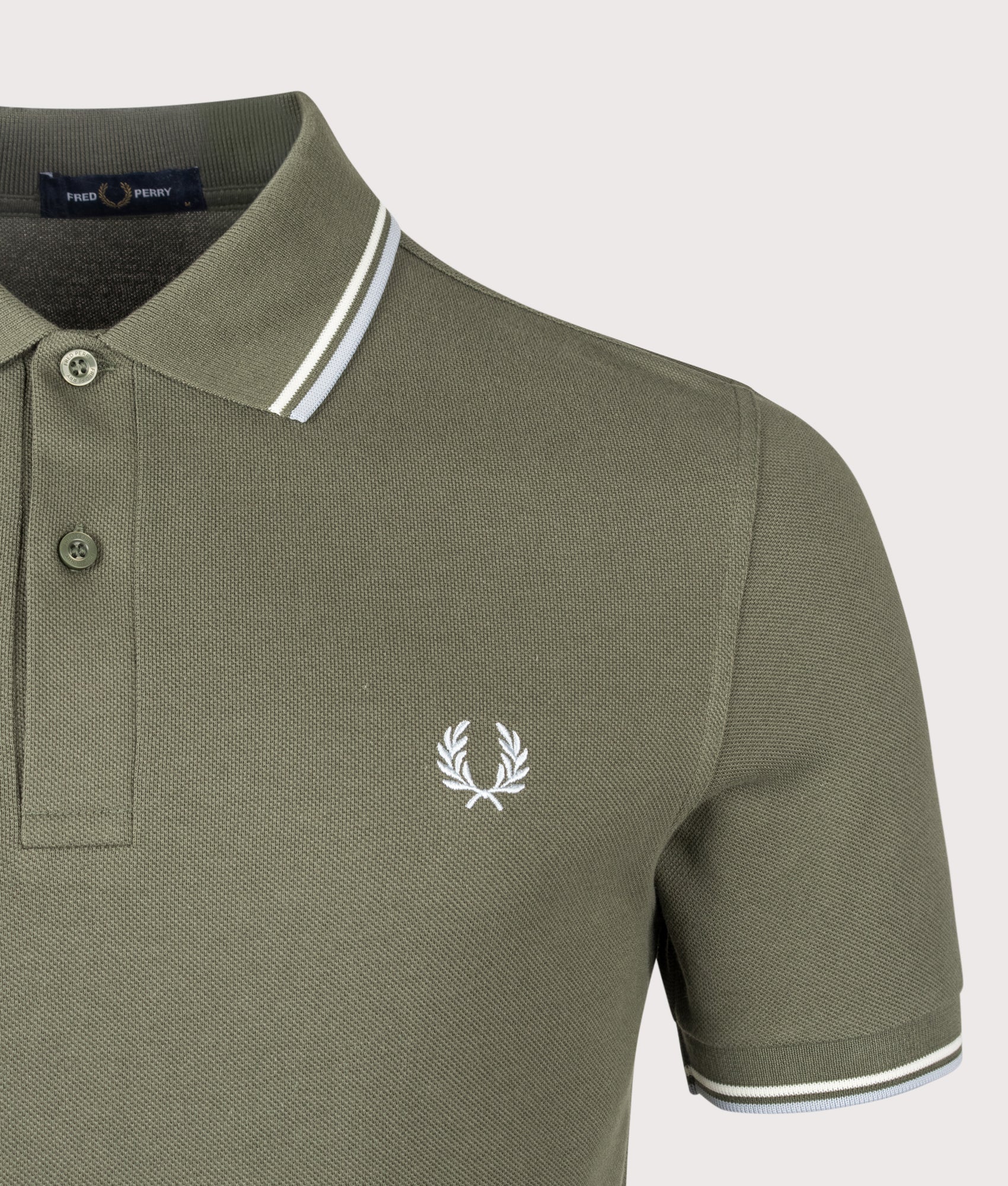 Fred Perry Twin Tipped Polo Shirt in Laurel Wreath Green, Ecru and Dusky Blue at EQVVS Menswear. Detail shot.