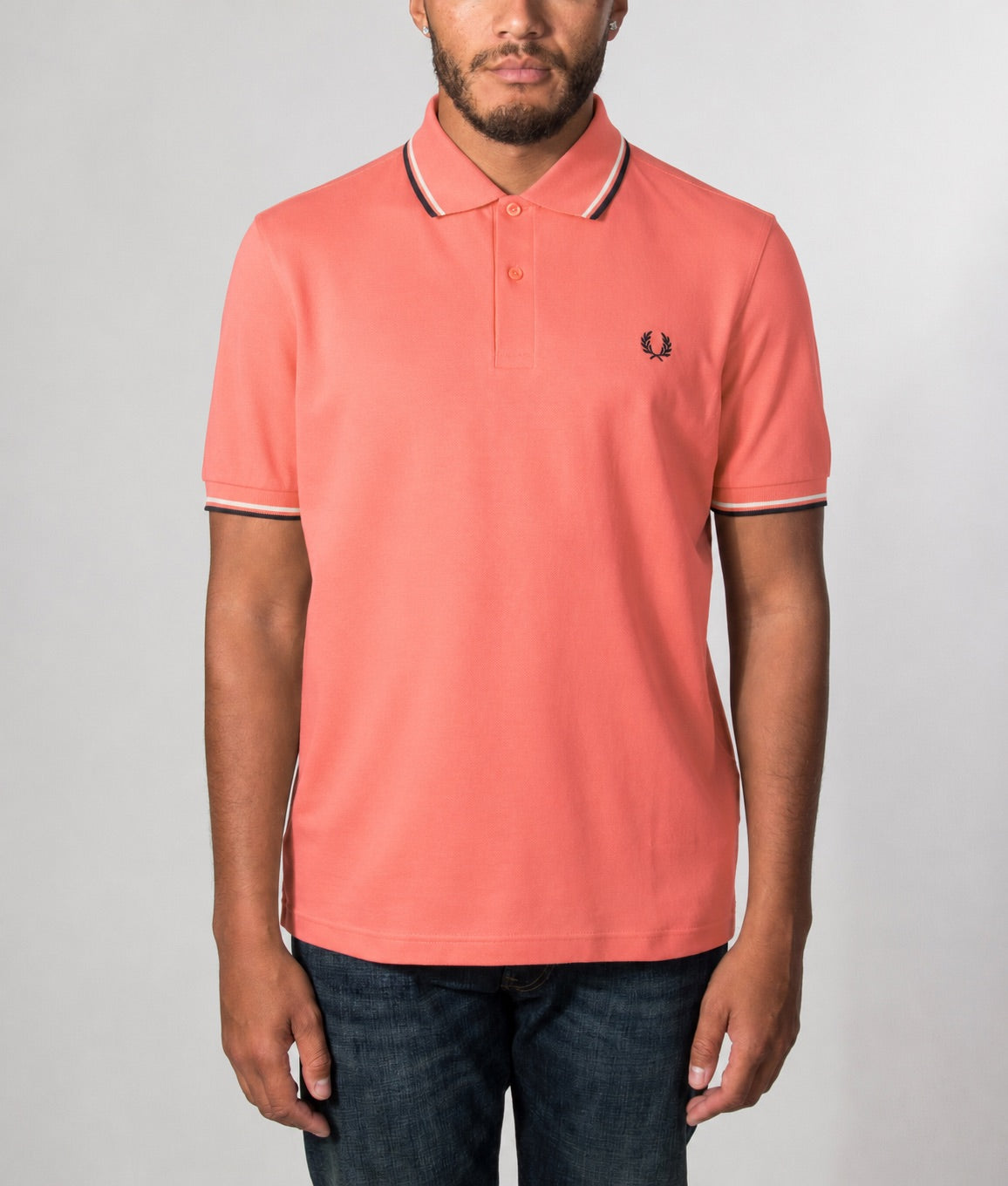 Fred Perry Twin Tipped Polo Shirt in Strawberry Cream, Ecru and Black at EQVVS Menswear. Model front shot.