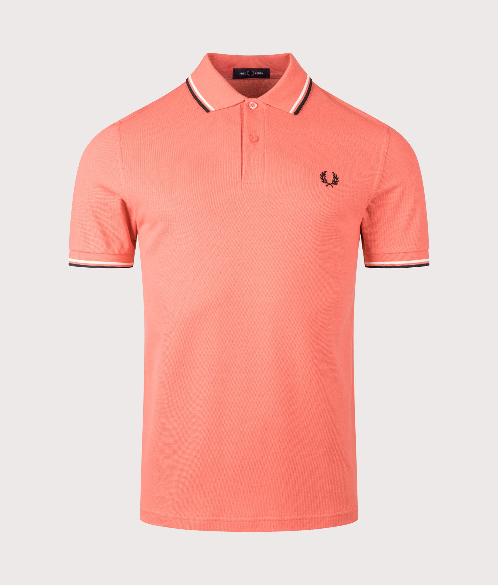 Fred Perry Twin Tipped Polo Shirt in Strawberry Cream, Ecru and Black at EQVVS Menswear. Front shot.