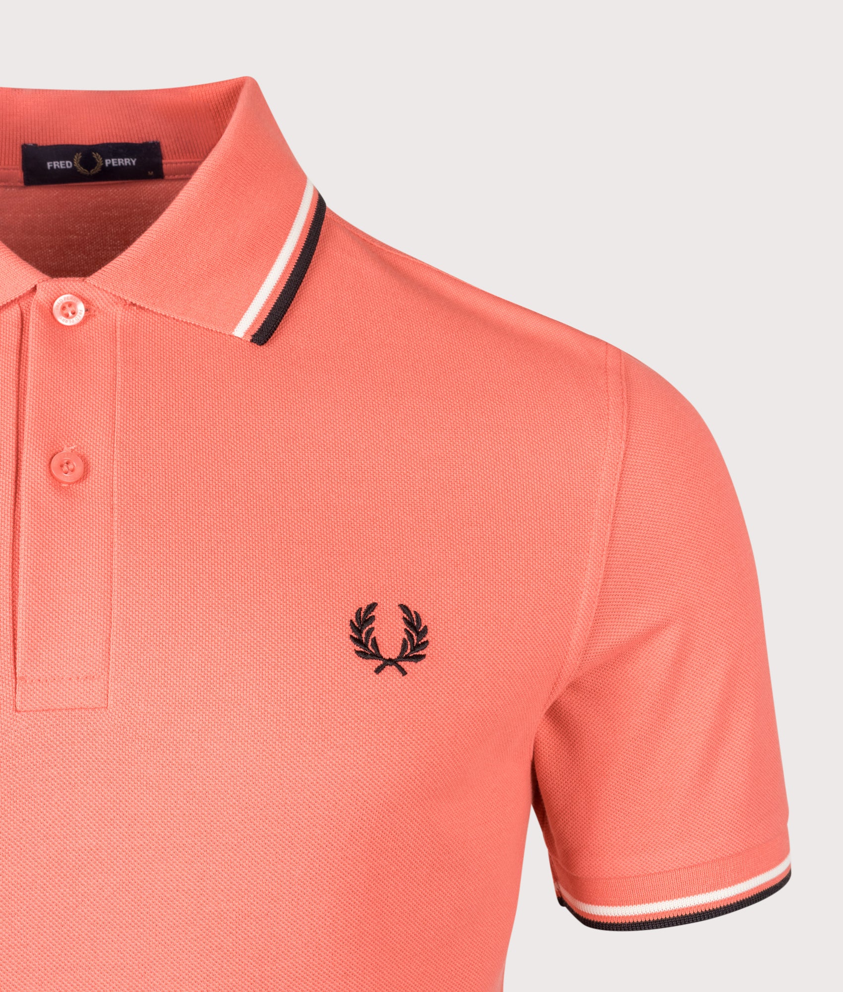 Fred Perry Twin Tipped Polo Shirt in Strawberry Cream, Ecru and Black at EQVVS Menswear. Detail shot.