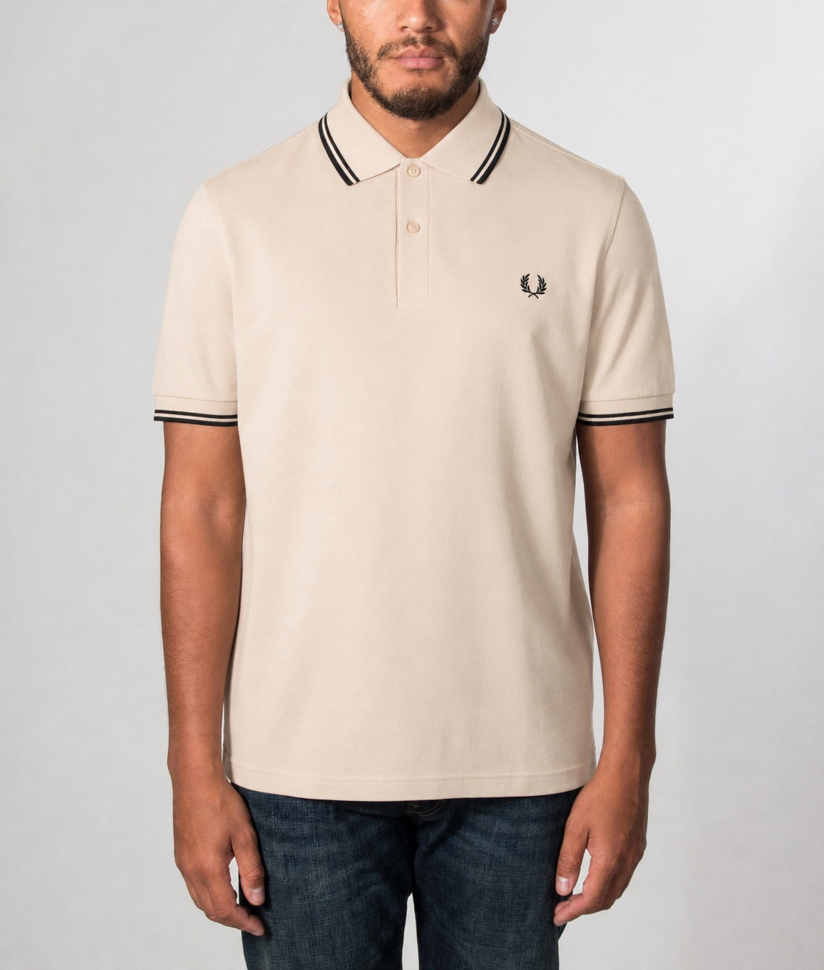 Fred Perry Twin Tipped Polo Shirt in Oatmeal and Black at EQVVS Menswear. Model front shot.