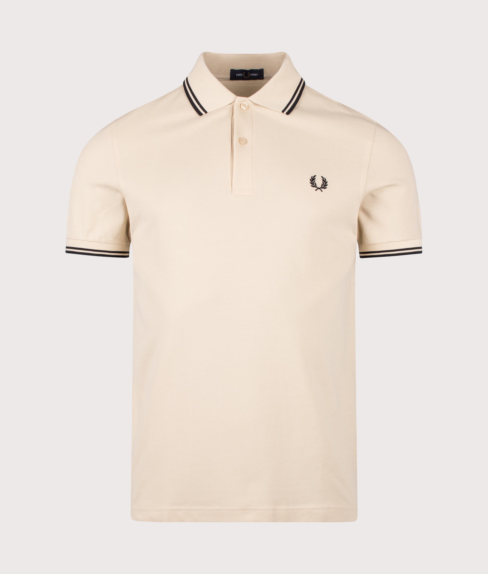 Fred Perry Twin Tipped Polo Shirt in Oatmeal and Black at EQVVS Menswear. Front shot.