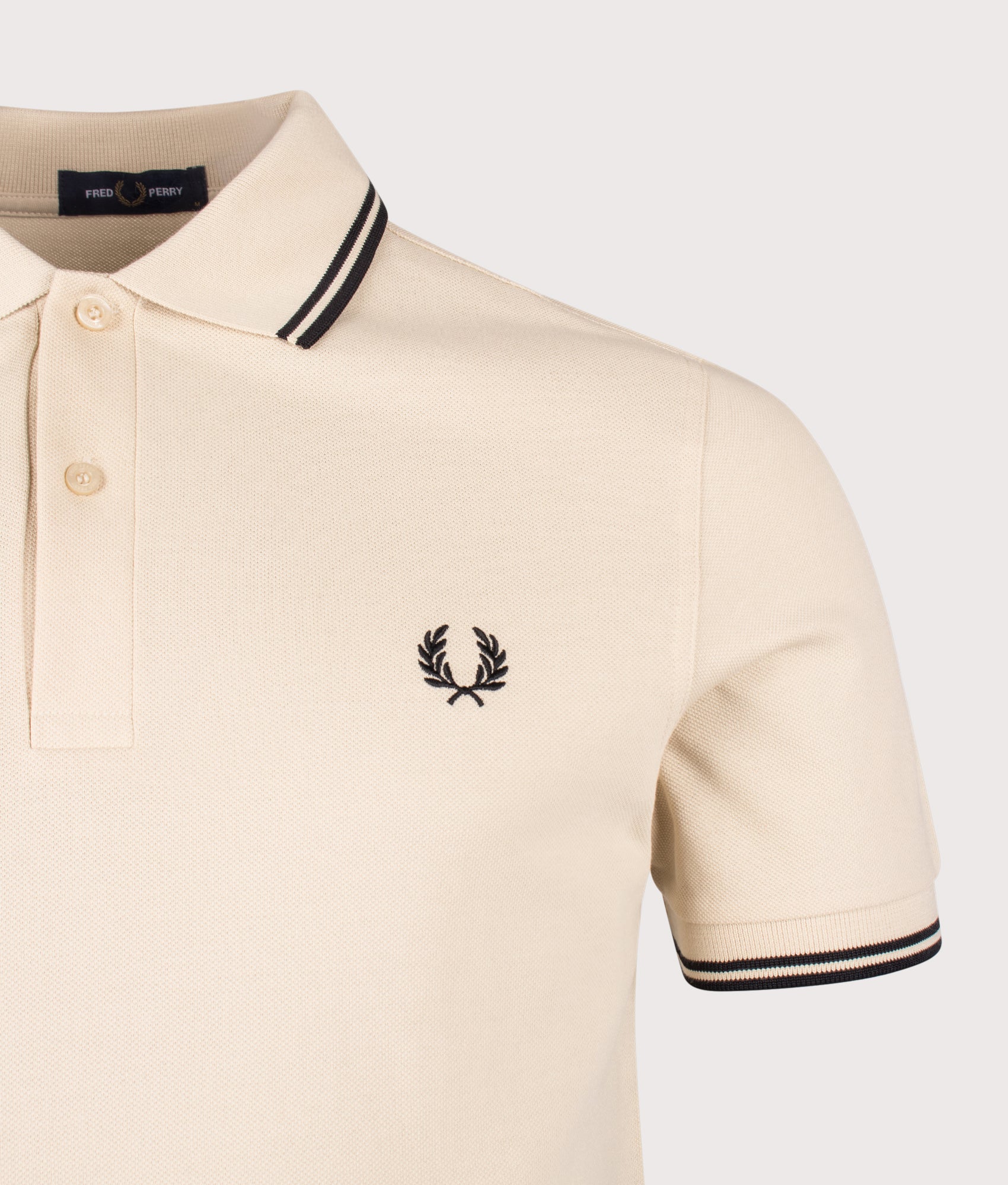 Fred Perry Twin Tipped Polo Shirt in Oatmeal and Black at EQVVS Menswear. Detail shot.