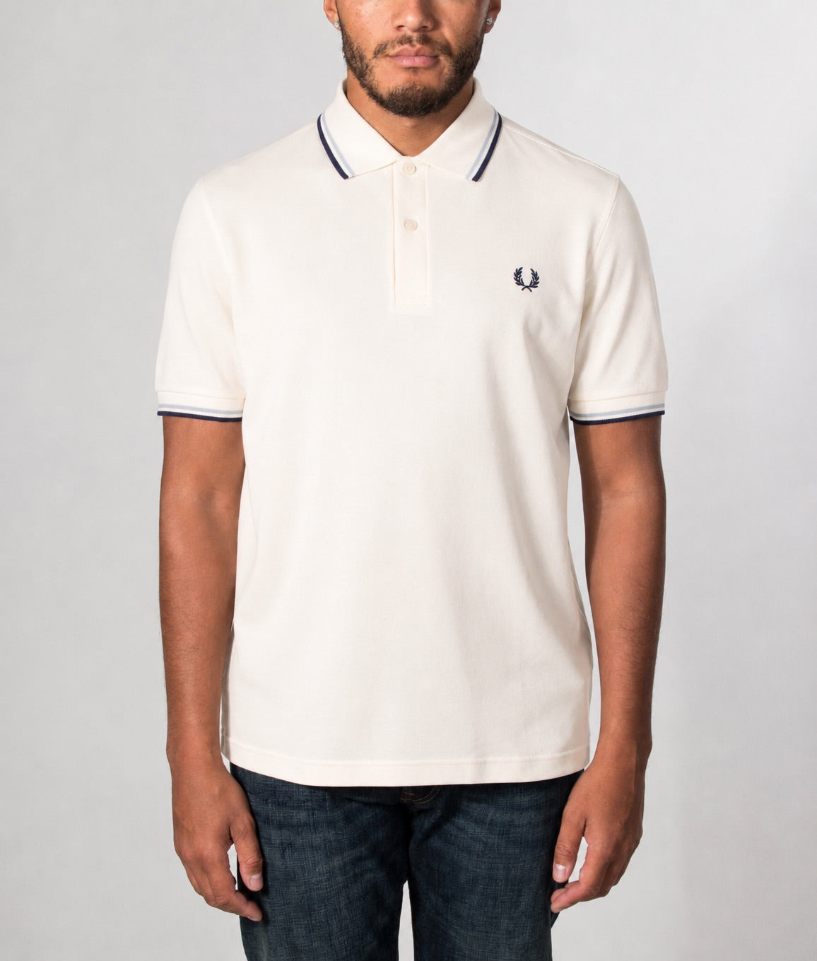 Fred Perry Twin Tipped Polo Shirt in Ecru, Dusky Blue and French Navy at EQVVS Menswear. Model front shot.