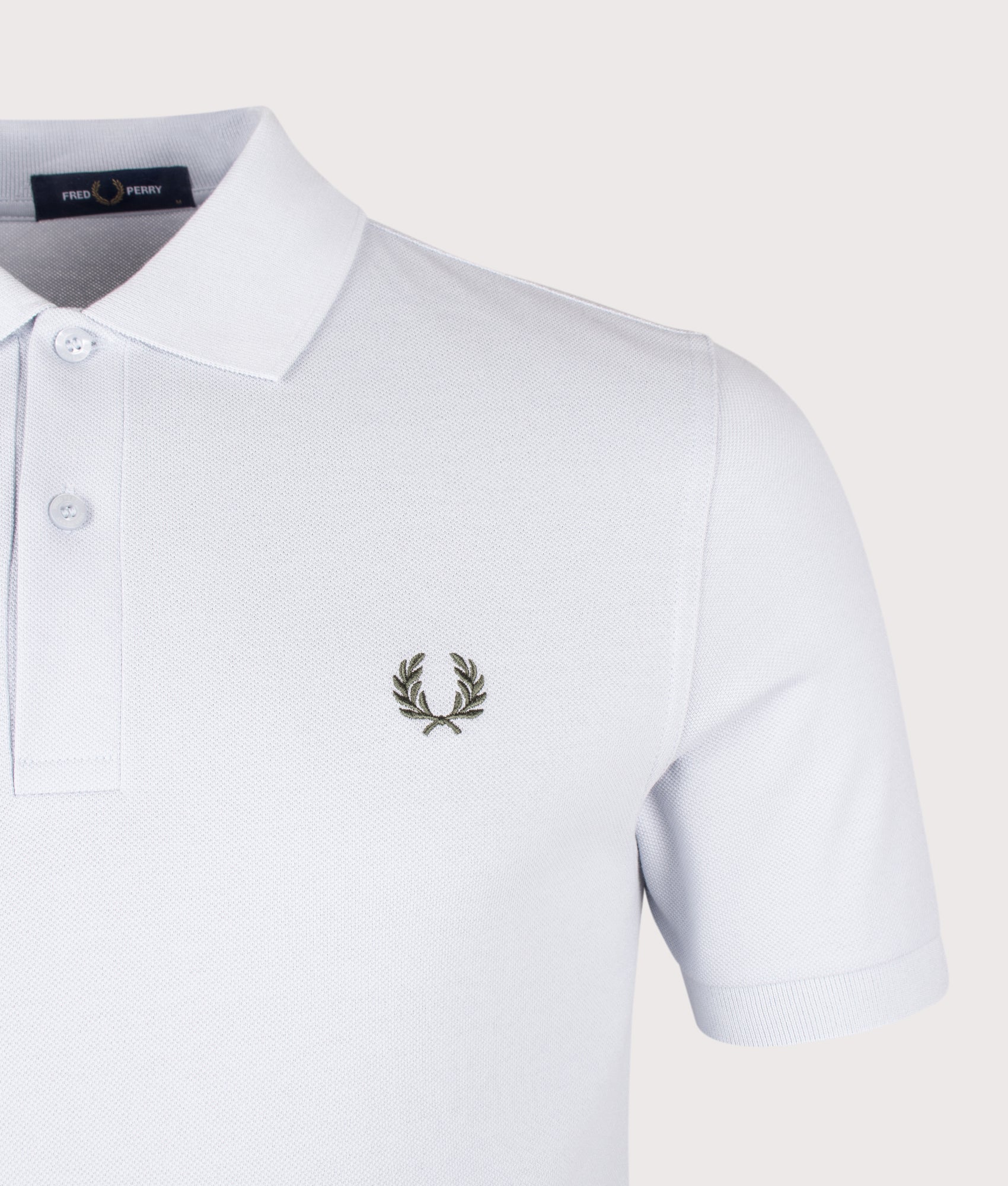 Fred Perry The Fred Perry Polo Shirt in Dusty Blue and Laurel Wreath Green at EQVVS Menswear. Detail shot.