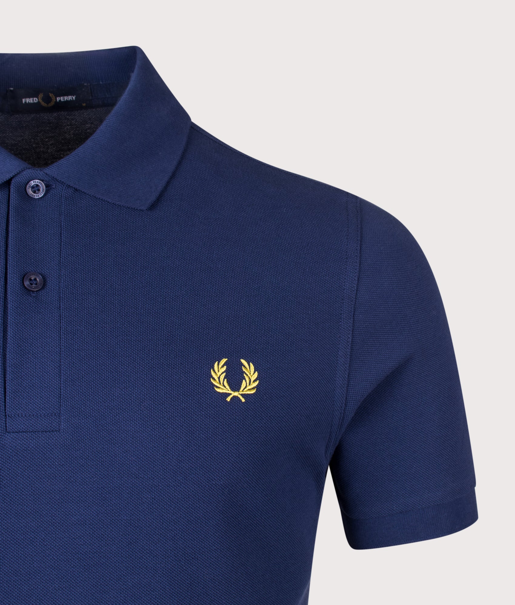 Fred Perry the The Fred Perry Polo Shirt in French Navy and Citron at EQVVS Menswear. Detail shot.