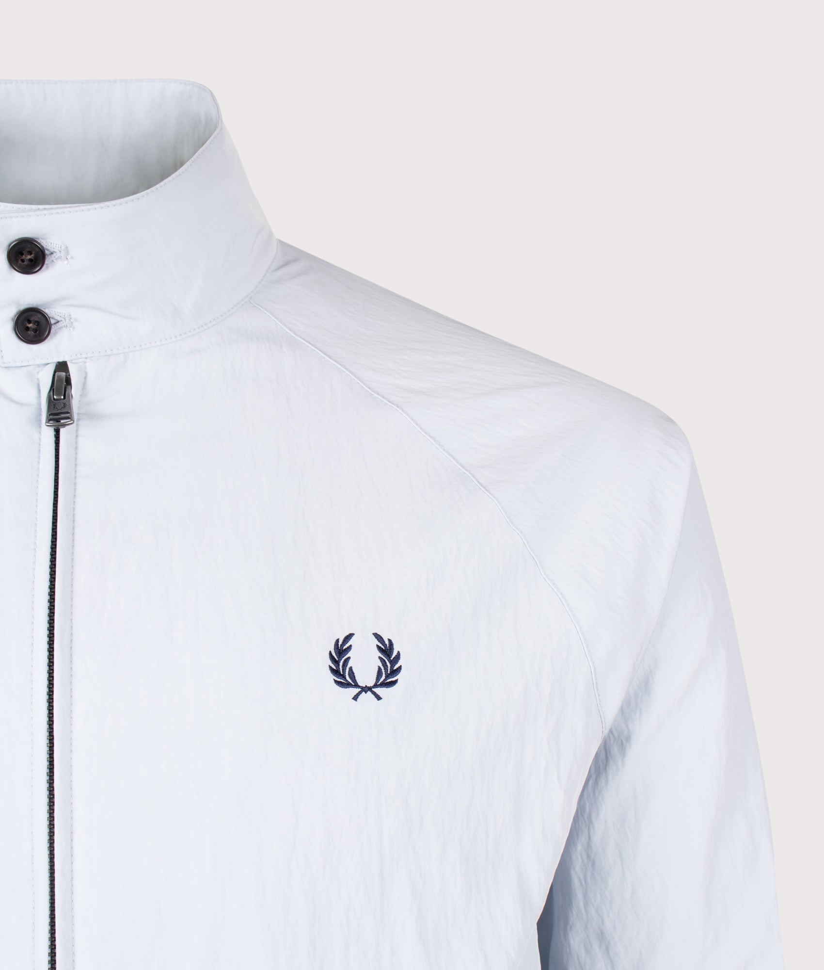 Fred Perry Crinkle Harrington Jacket in Dusky Blue at EQVVS Menswear. Detail shot.