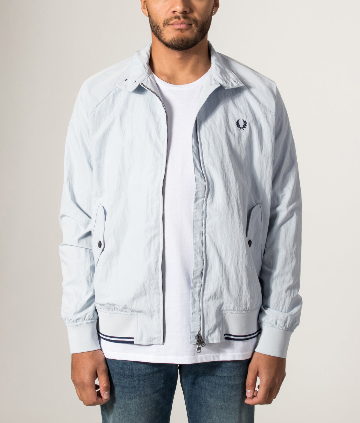 Fred Perry Crinkle Harrington Jacket in Dusky Blue at EQVVS Menswear. Model front shot.