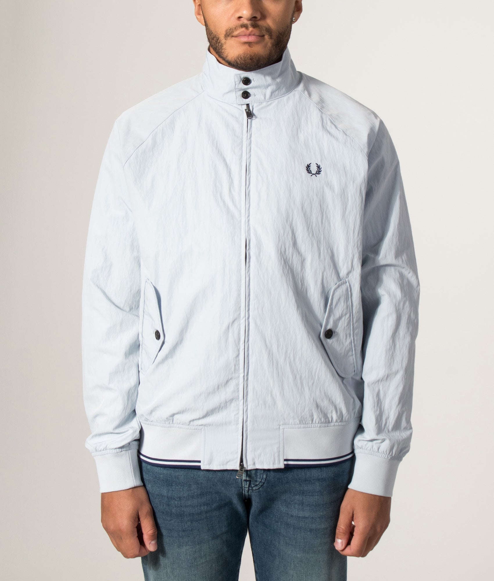 Fred Perry Crinkle Harrington Jacket in Dusky Blue at EQVVS Menswear. Model front shot.