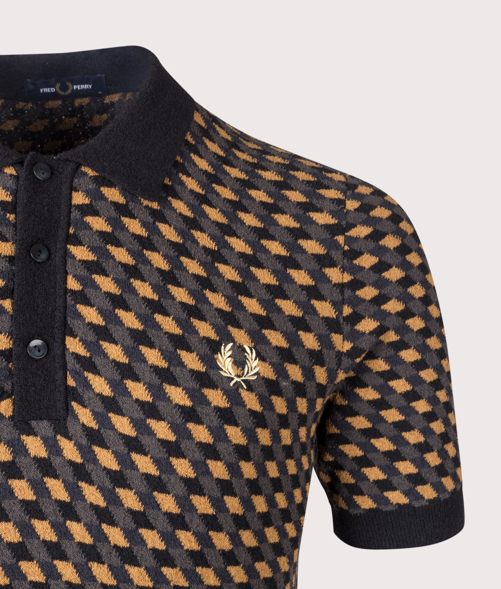 Fred Perry Geometric Knitted Polo Shirt in Dark Caramel at EQVVS Menswear. Detail shot.