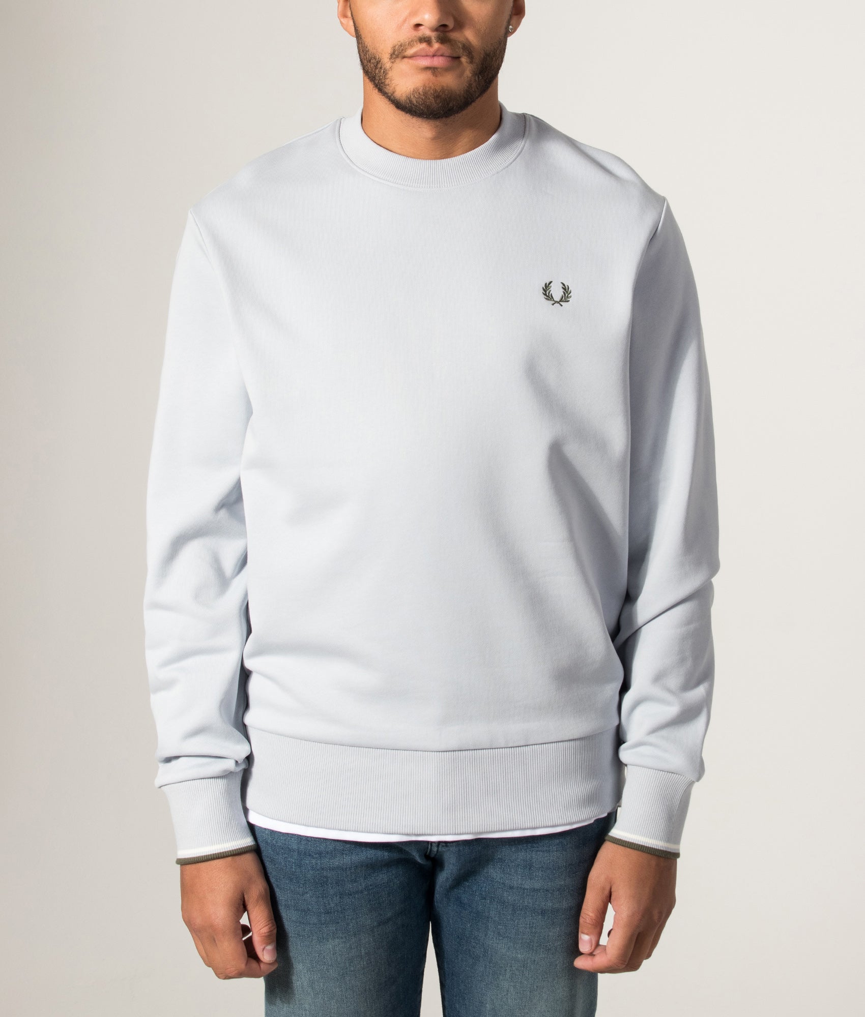 Fred Perry Crew Neck Sweatshirt in Dusky Blue, Ecru and Laurel Wreath Green at EQVVS Menswear. Model front shot.