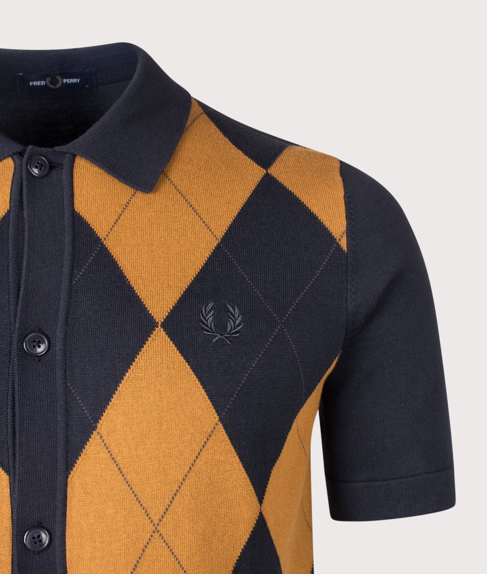 Fred Perry Argyle Button Through Knitted Shirt in Navy at EQVVS Menswear. Detail shot.