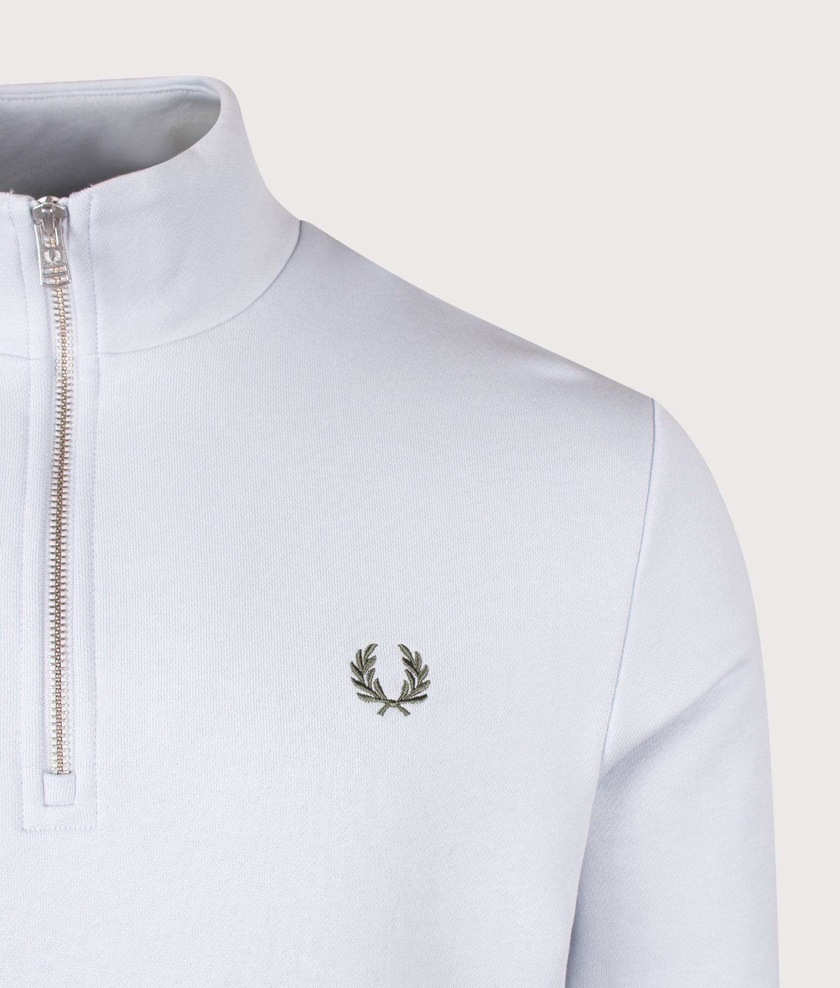 Fred Perry Quarter Zip Sweatshirt in Dusky Blue, Ecru and Laurel Wreath Green at EQVVS Menswear. Detail shot.