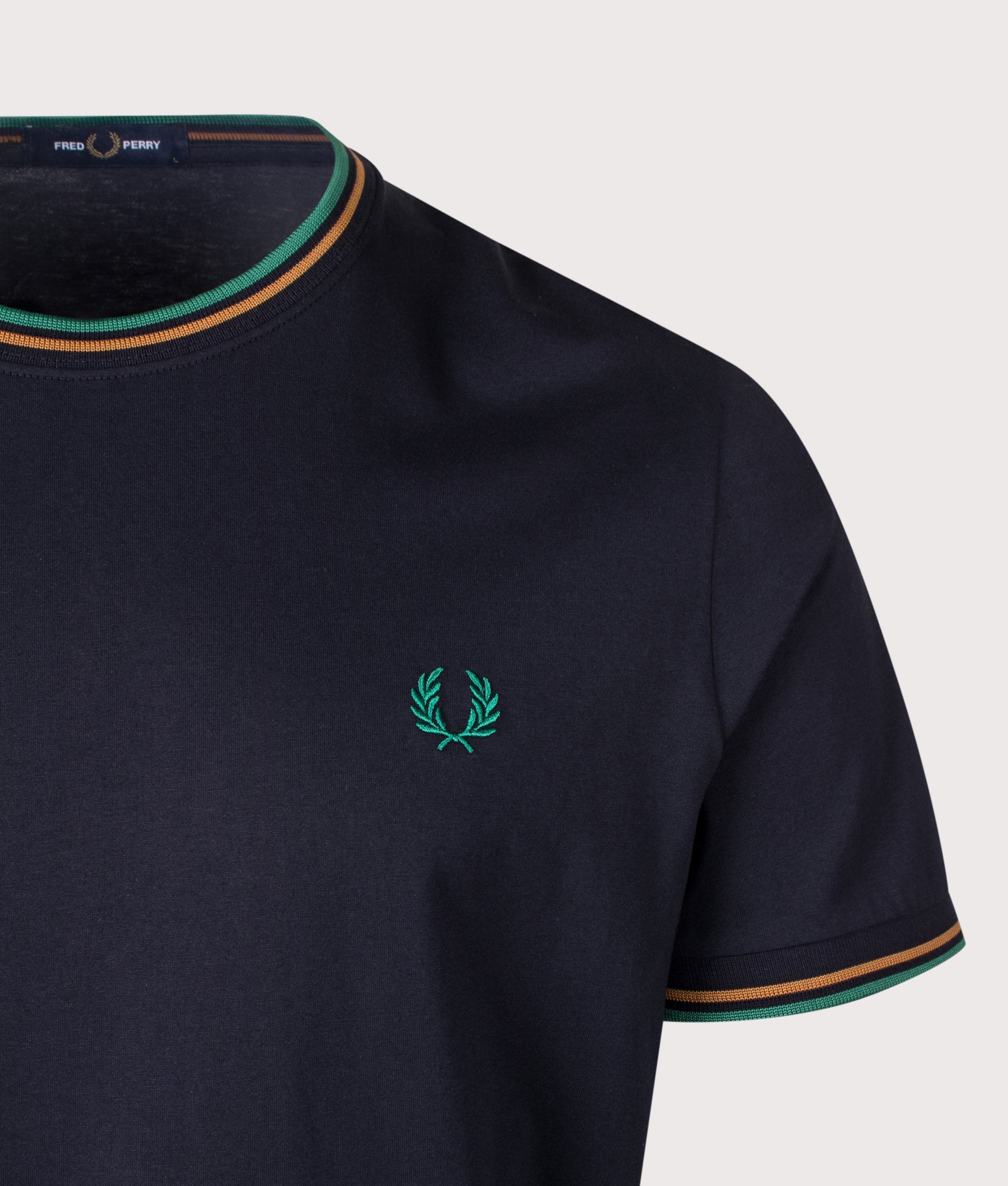 Fred Perry Regular Fit Twin Tipped T-Shirt in Navy, Dark Caramel and Sport Green at EQVVS Menswear. Detail Shot.