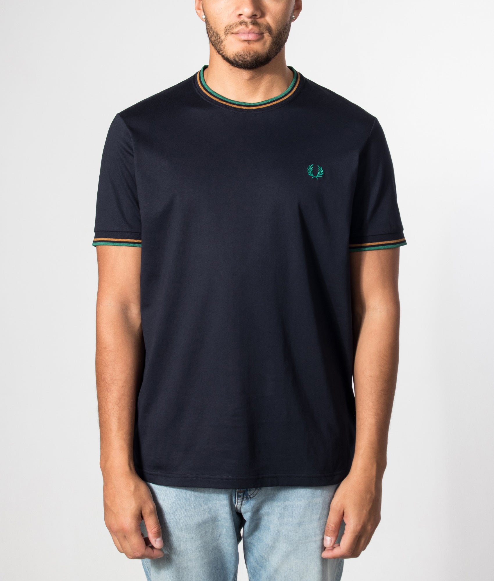 Fred Perry Regular Fit Twin Tipped T-Shirt in Navy, Dark Caramel and Sport Green at EQVVS Menswear. Model front shot.