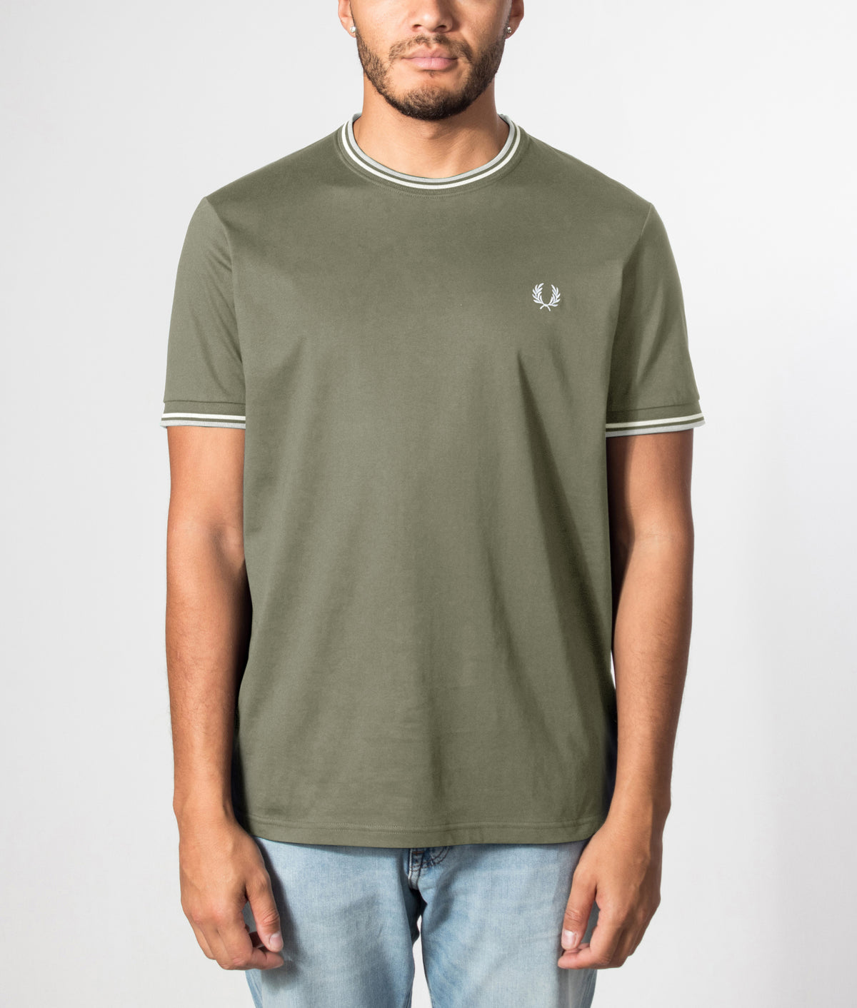 Fred Perry Twin Tipped T-Shirt in Laurel Wreath Green, Ecru and Dusky Blue at EQVVS Menswear. Front model shot.