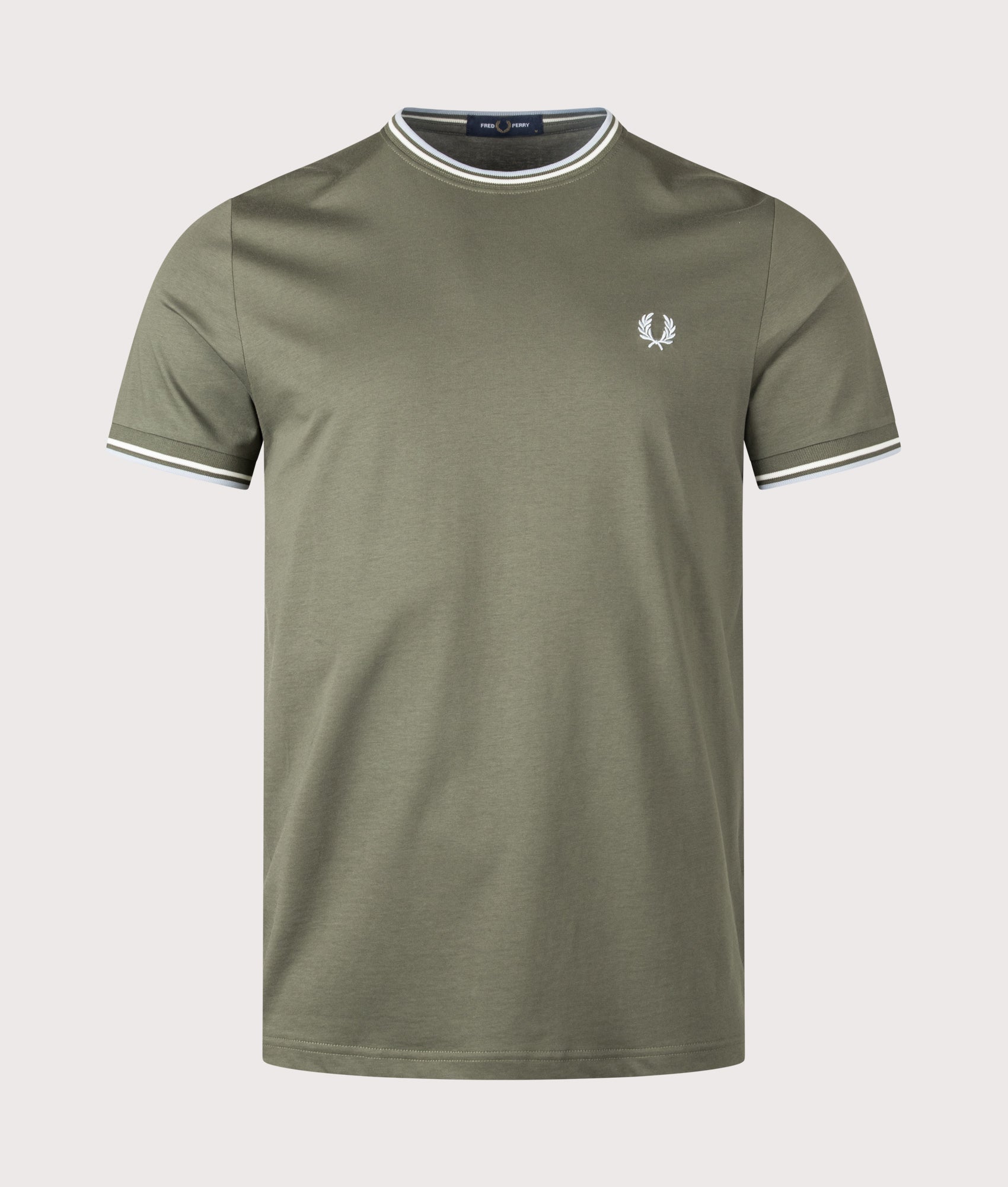 Fred Perry Twin Tipped T-Shirt in Laurel Wreath Green, Ecru and Dusky Blue at EQVVS Menswear. Model front shot.