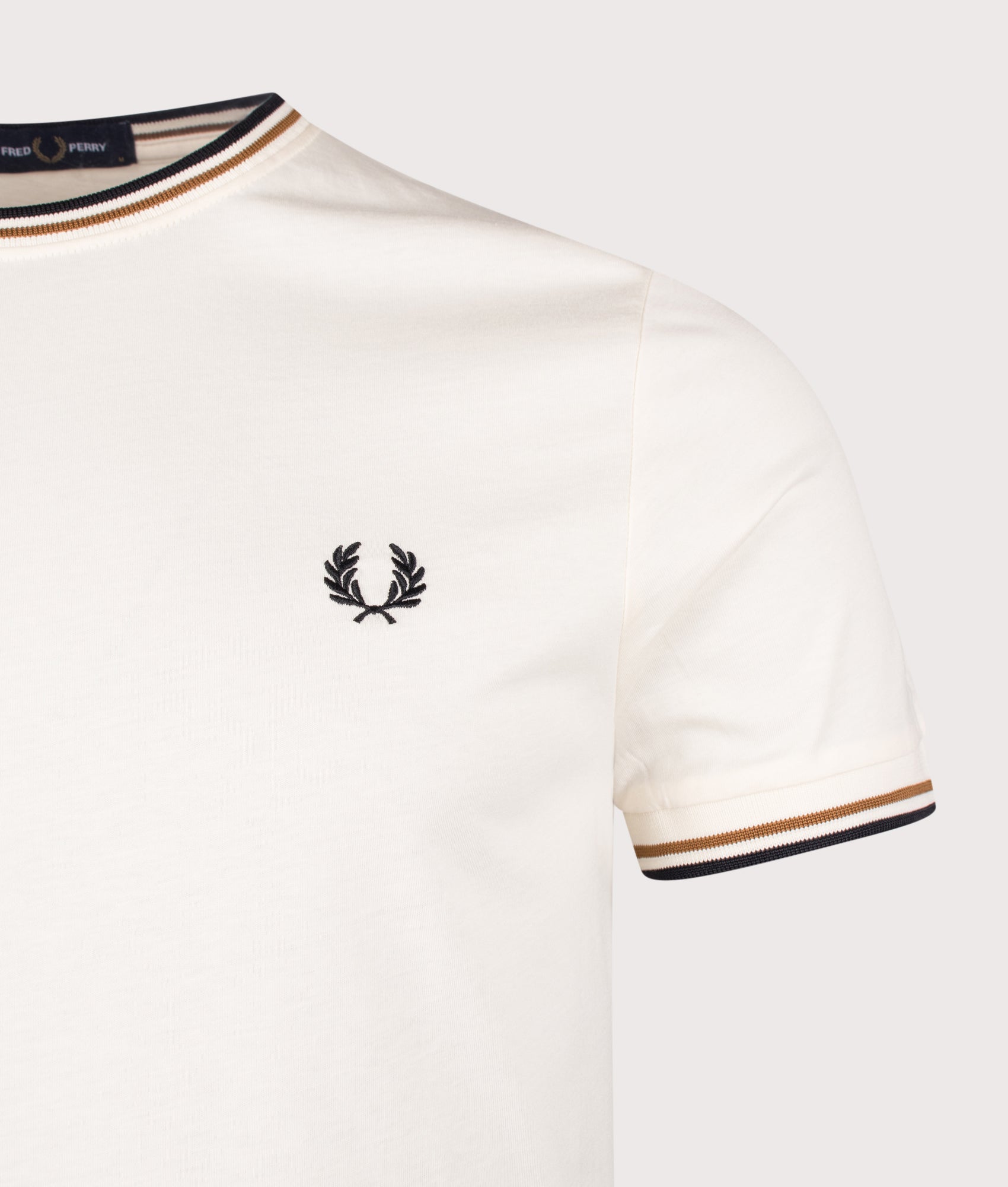 Fred Perry Twin Tipped T-Shirt in Dark Ecru, Dark Caramel and Black at EQVVS Menswear. Detail shot.