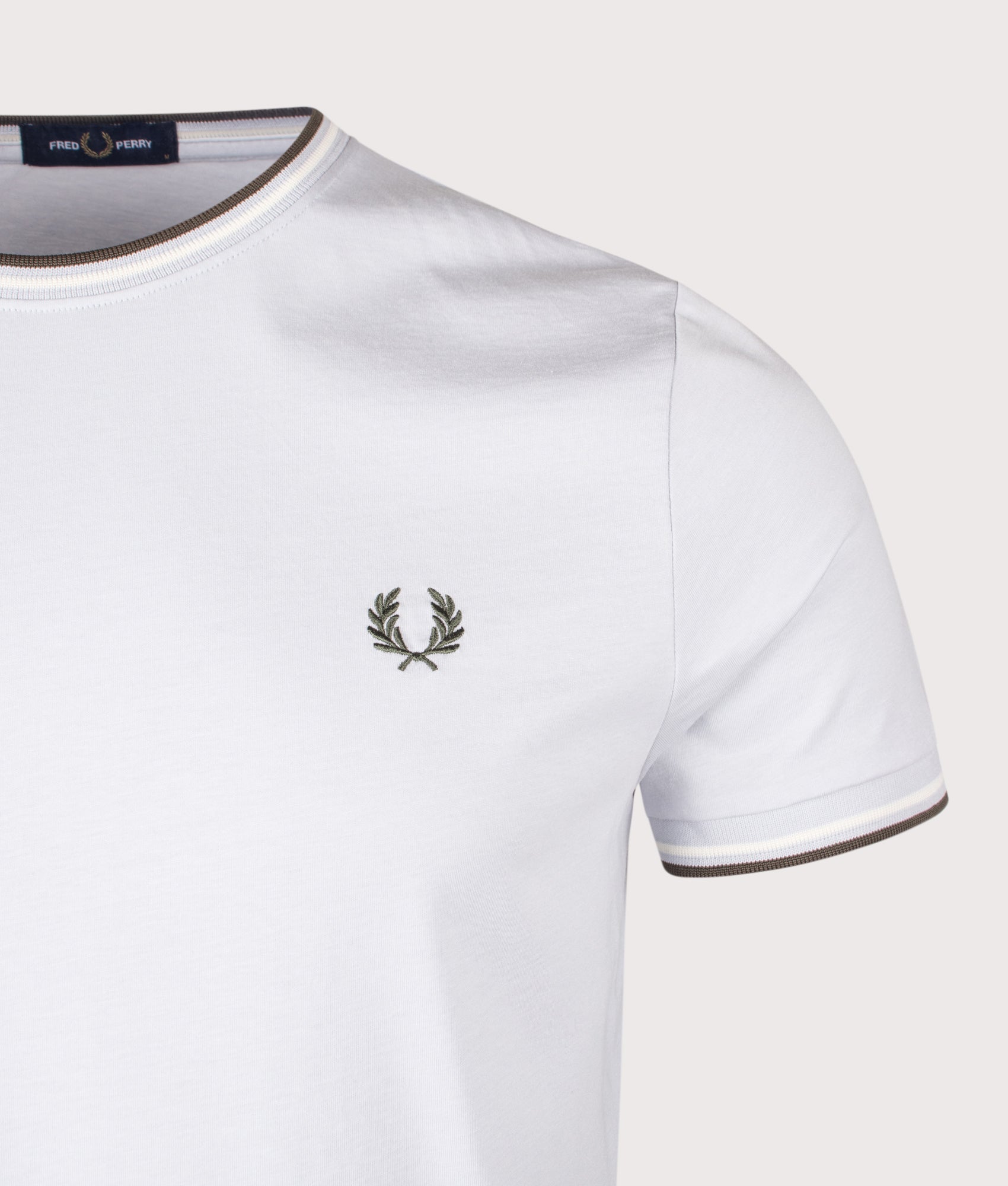 Fred Perry Twin Tipped T-Shirt in Dusky Blue, Ecru and Laurel Wreath Green at EQVVS Menswear. Detail shot.