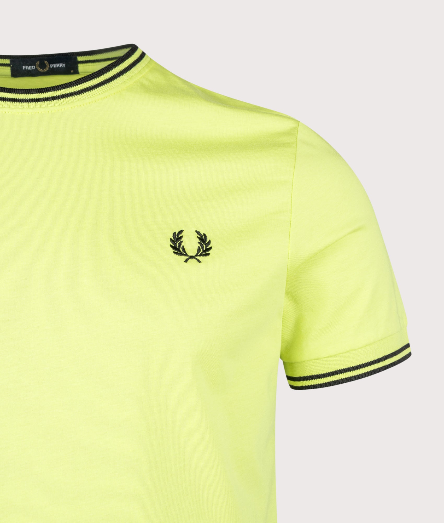 Fred Perry Twin Tipped T-Shirt in Citron and Black at EQVVS Menswear. Detail shot.