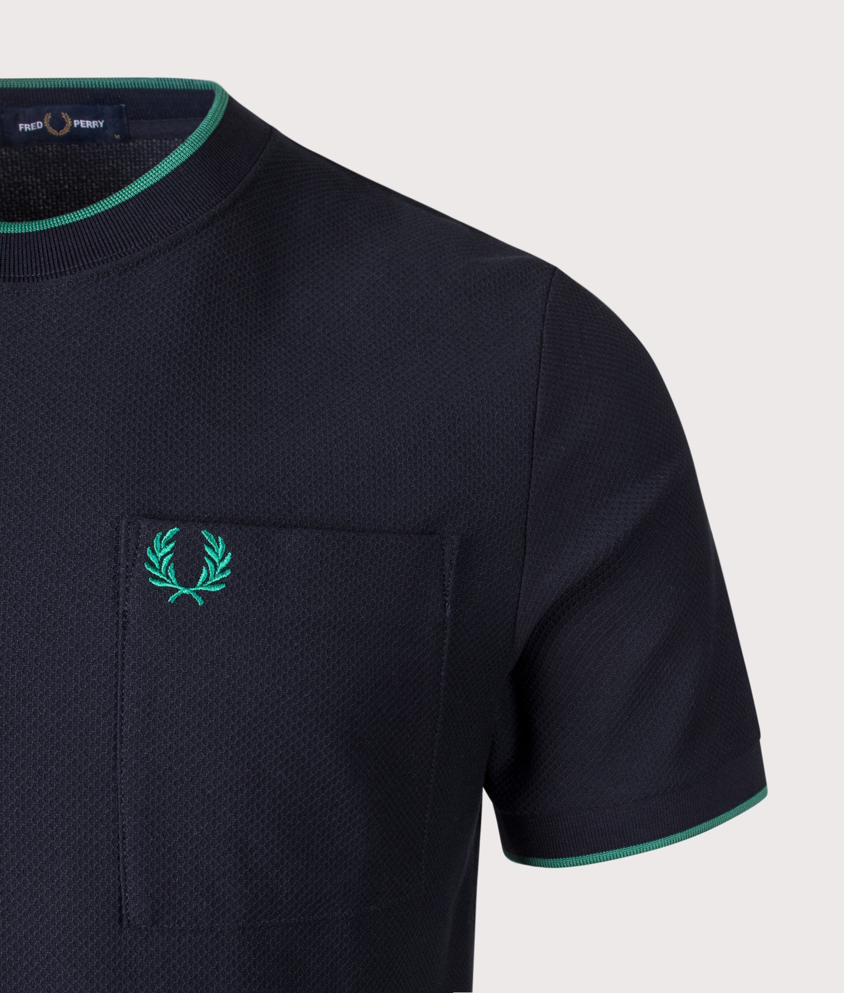 Fred Perry Pocket Detail Piqué T-Shirt in Navy at EQVVS Menswear. Detail shot.