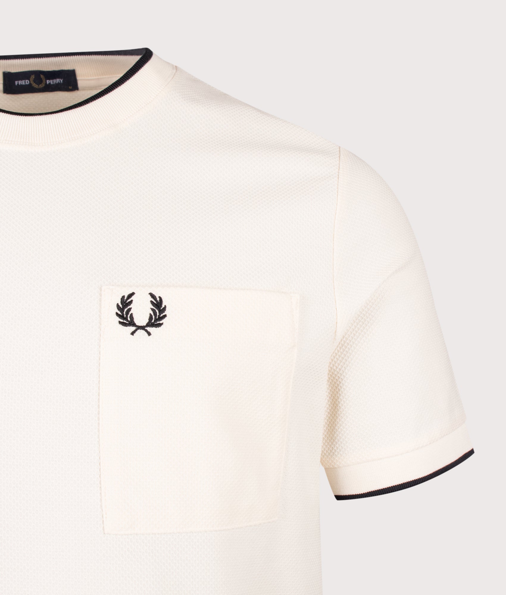 Fred Perry Pocket Detail Piqué T-Shirt in  Ecru at EQVVS Menswear. Detail shot.