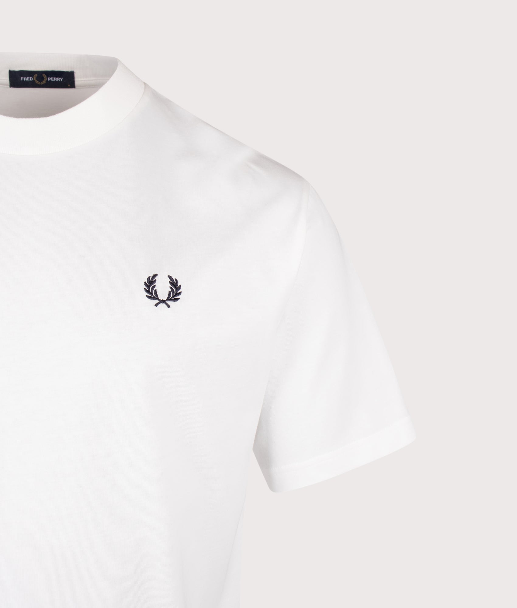 Fred Perry Relaxed Fit Back Print Fred Perry Text T-Shirt in Snow White at EQVVS Menswear. Detail shot.