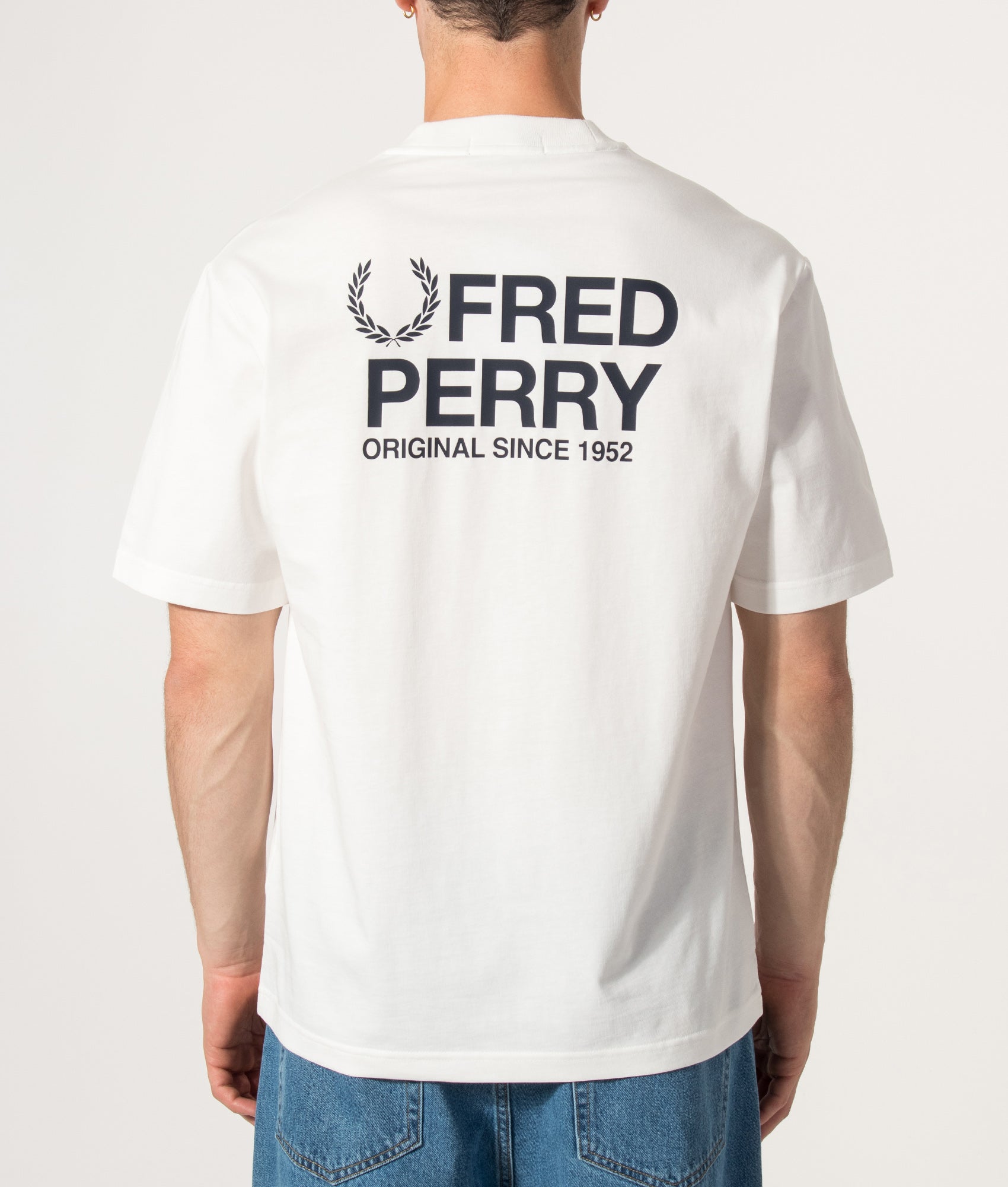 Fred Perry Relaxed Fit Back Print Fred Perry Text T-Shirt in Snow White at EQVVS Menswear. Model back shot.
