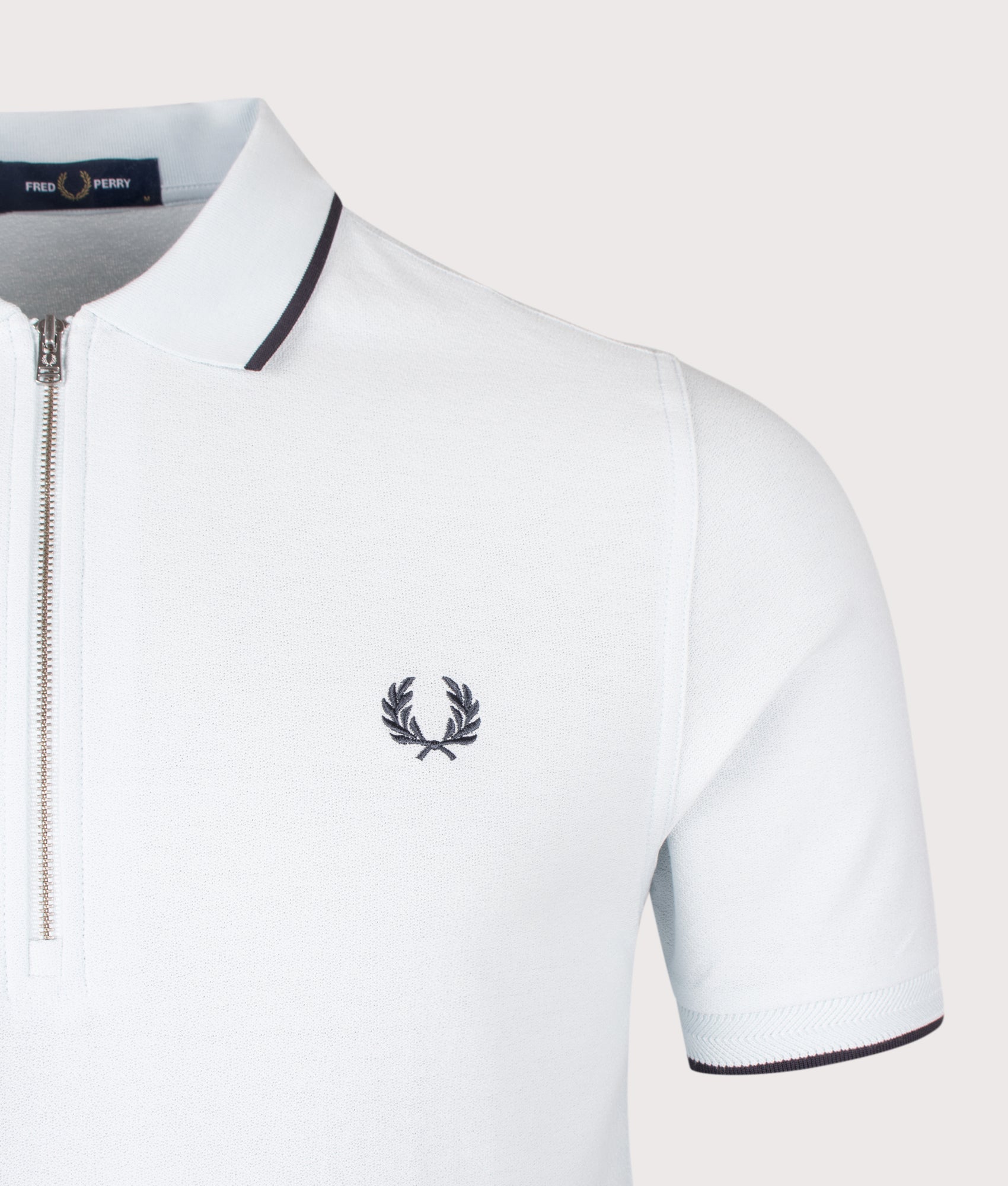 Fred Perry Crepe Piqué Polo Shirt in Light Ice at EQVVS Menswear. Detail shot.