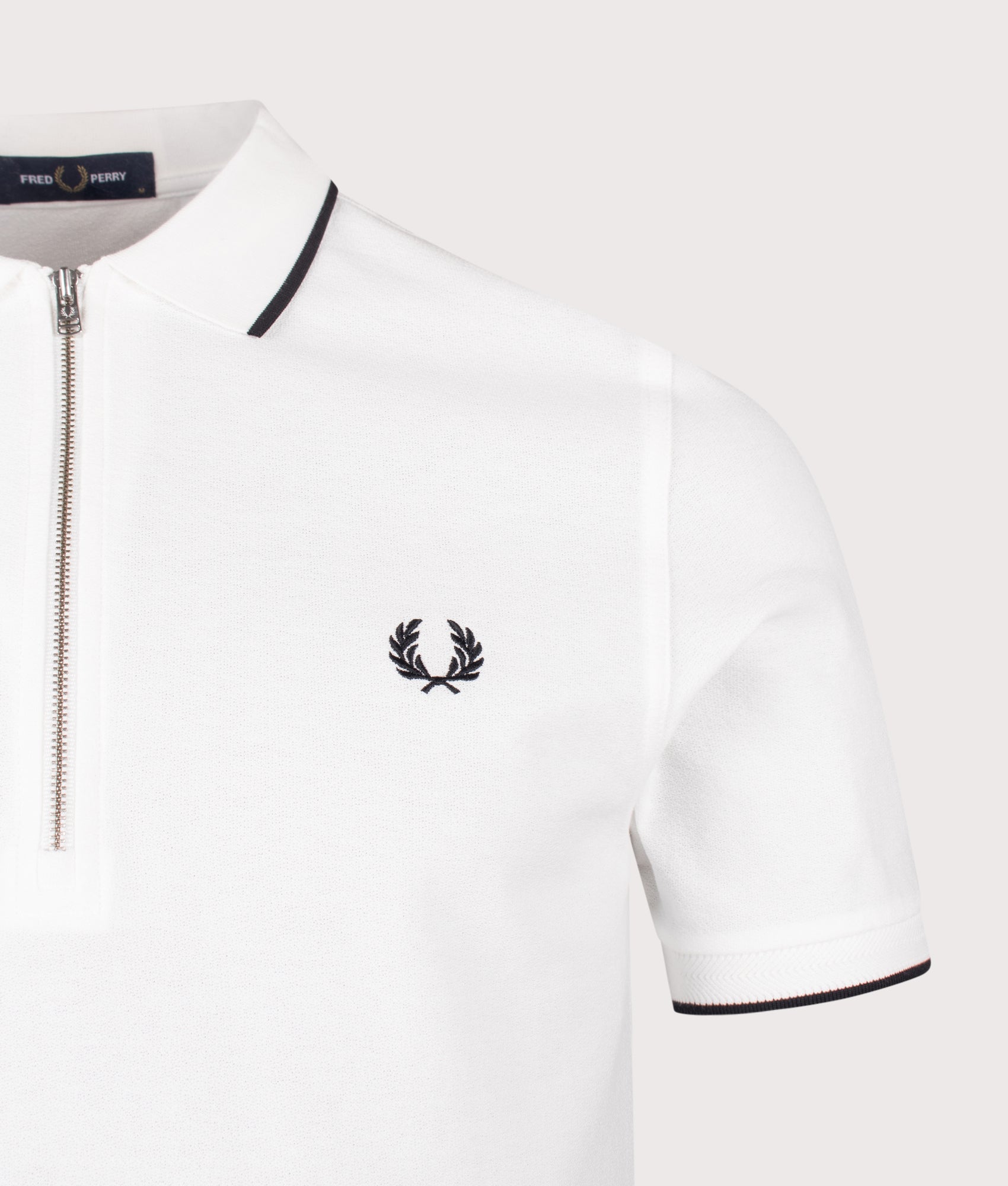Fred Perry Crepe Piqué Polo Shirt in Snow White at EQVVS Menswear. Detail shot.