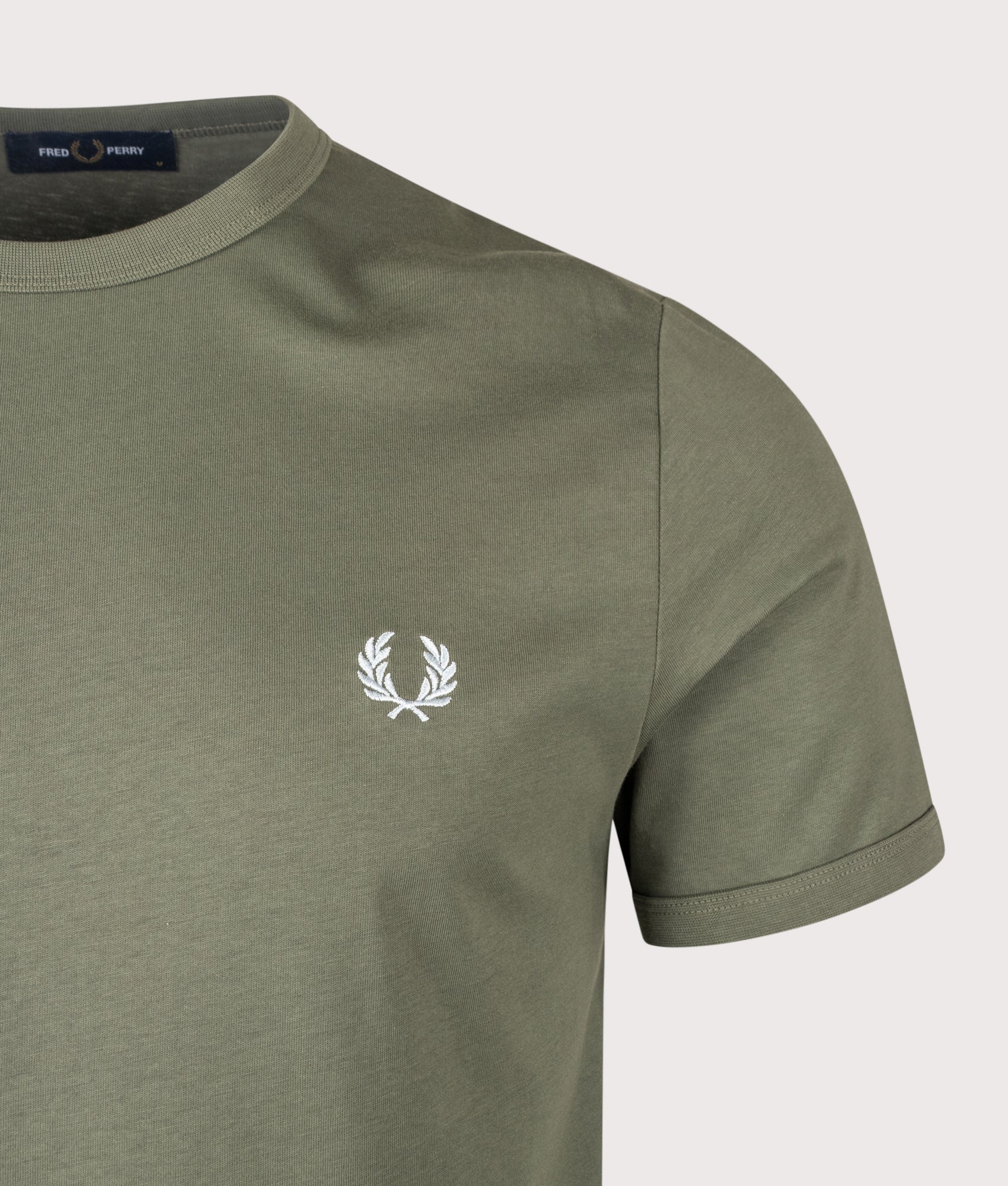 Fred Perry Ringer T-Shirt in Laurel Wreath Green at EQVVS Menswear. Detail shot.