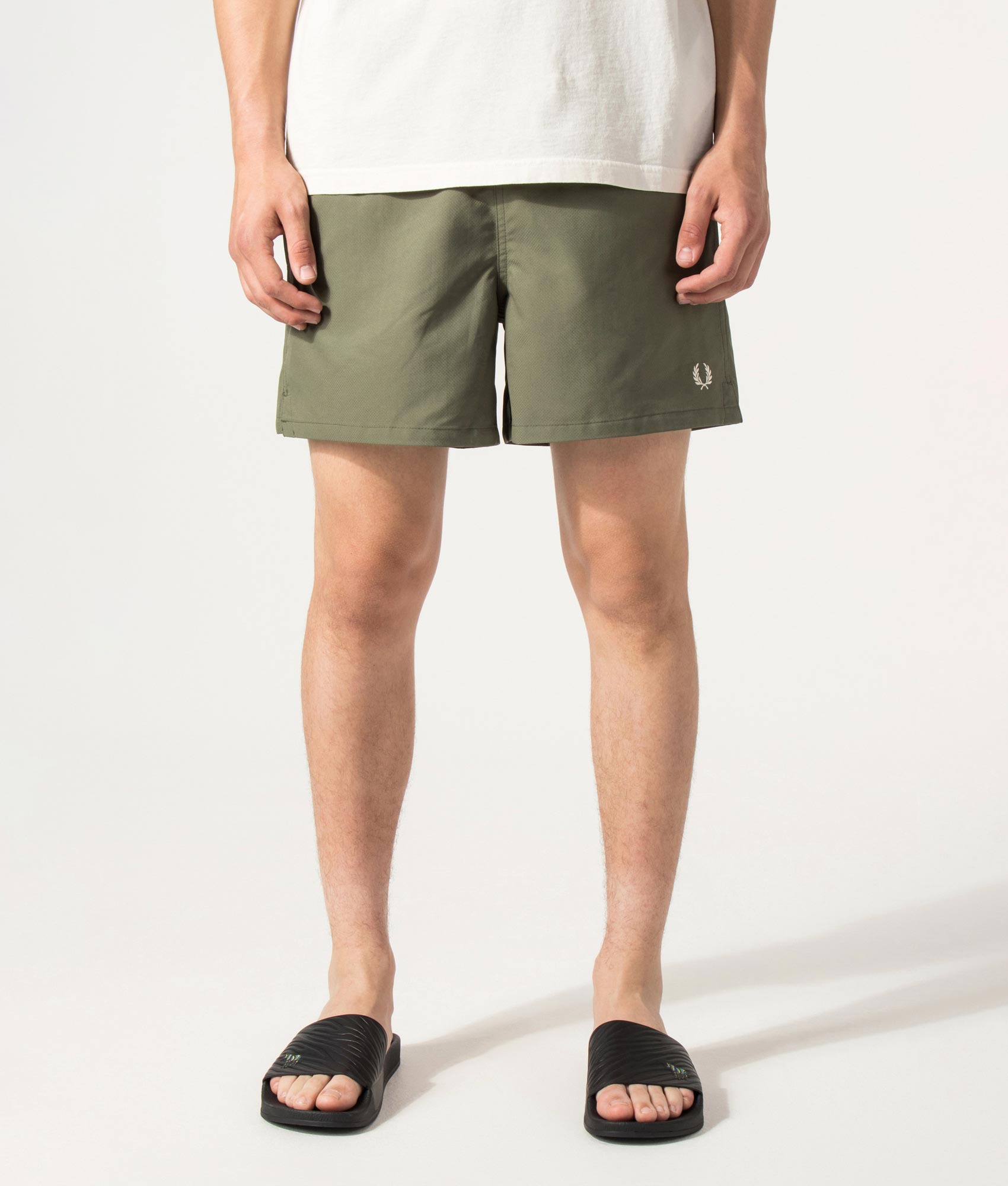 Fred Perry Swimshorts in Laurel Wreath Green at EQVVS Menswear. Model front shot.
