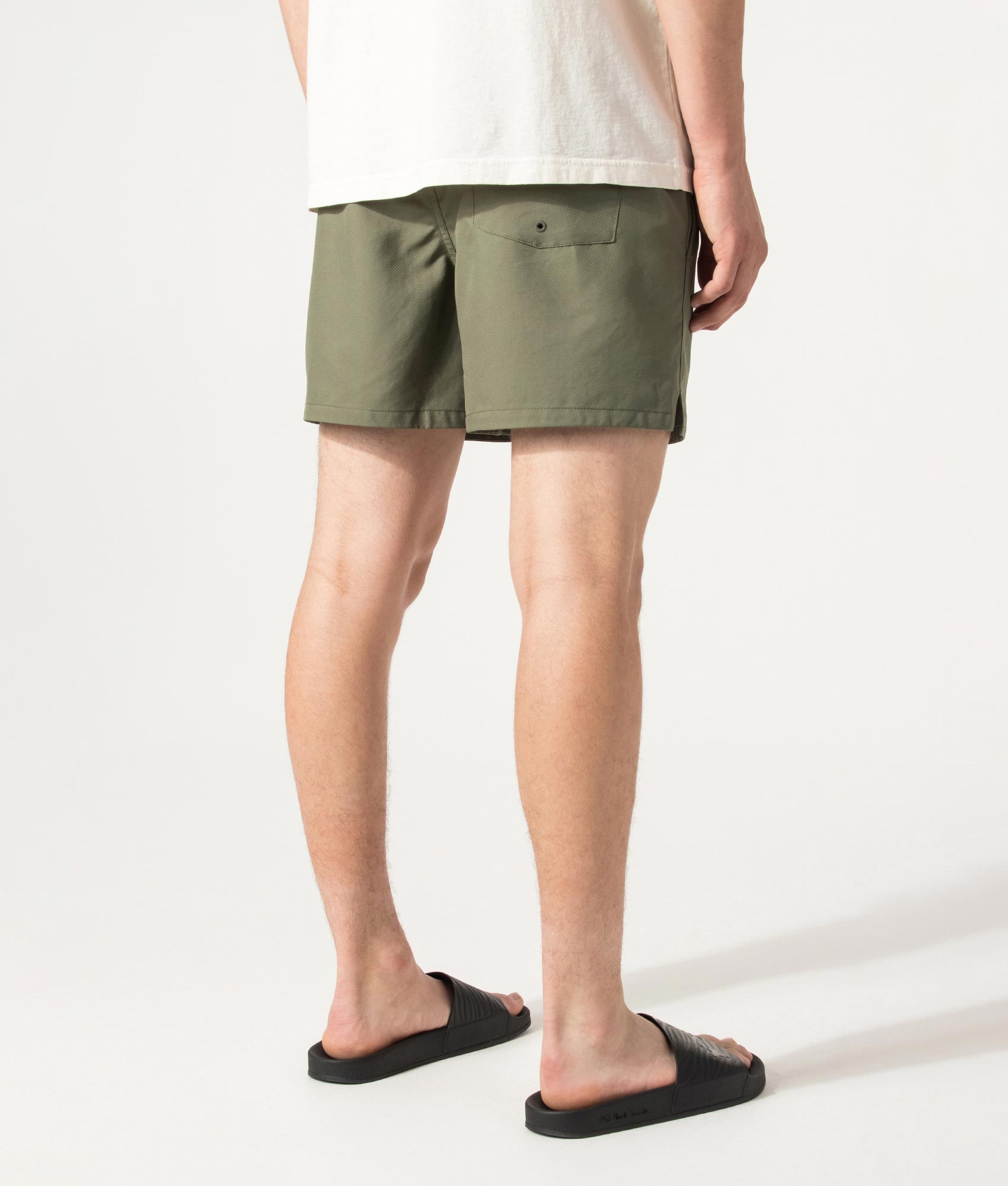 Fred Perry Swimshorts in Laurel Wreath Green at EQVVS Menswear. Angled model back shot.
