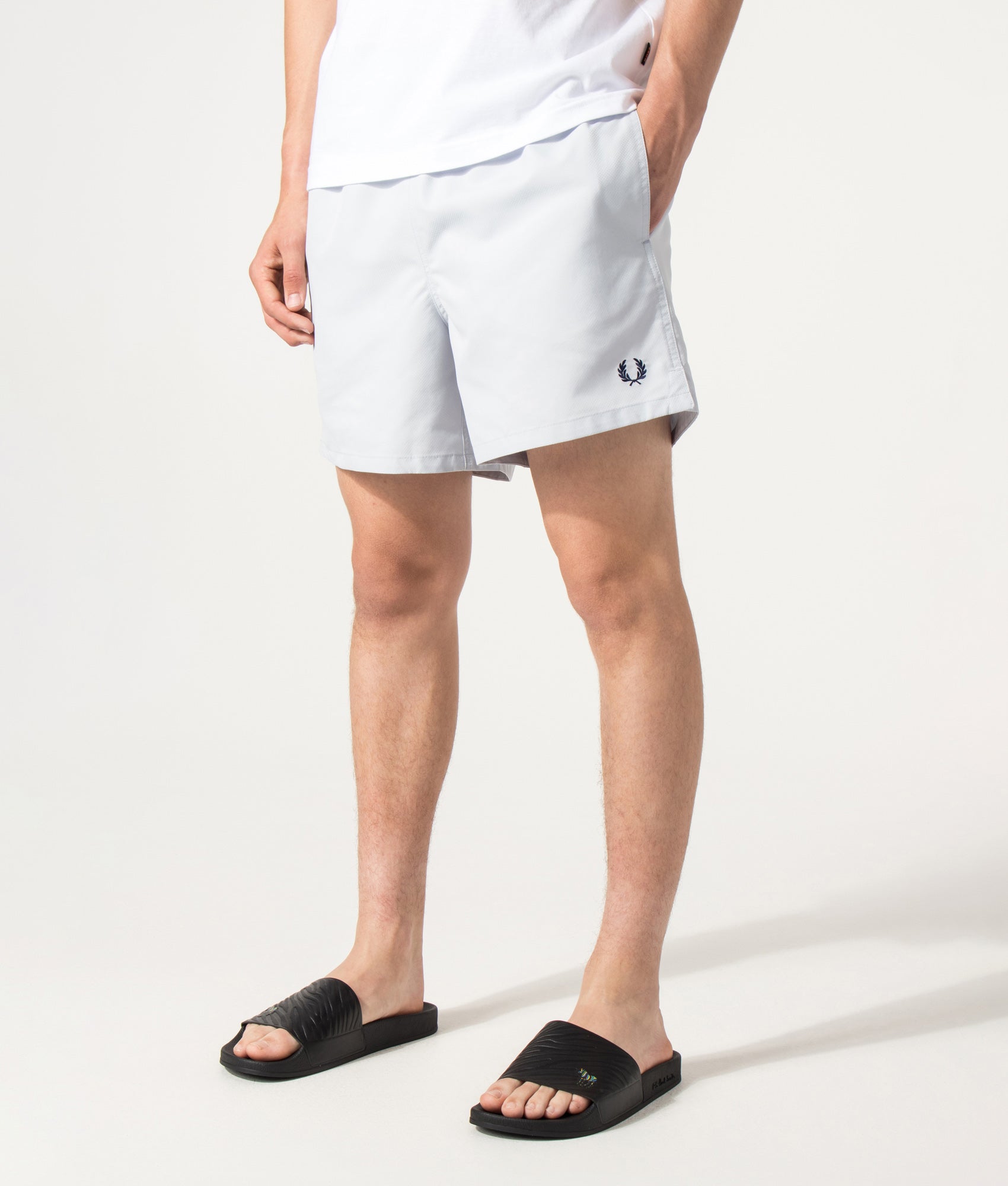 Fred Perry Swimshorts in Dusky blue at EQVVS Menswear. Angled model front shot.