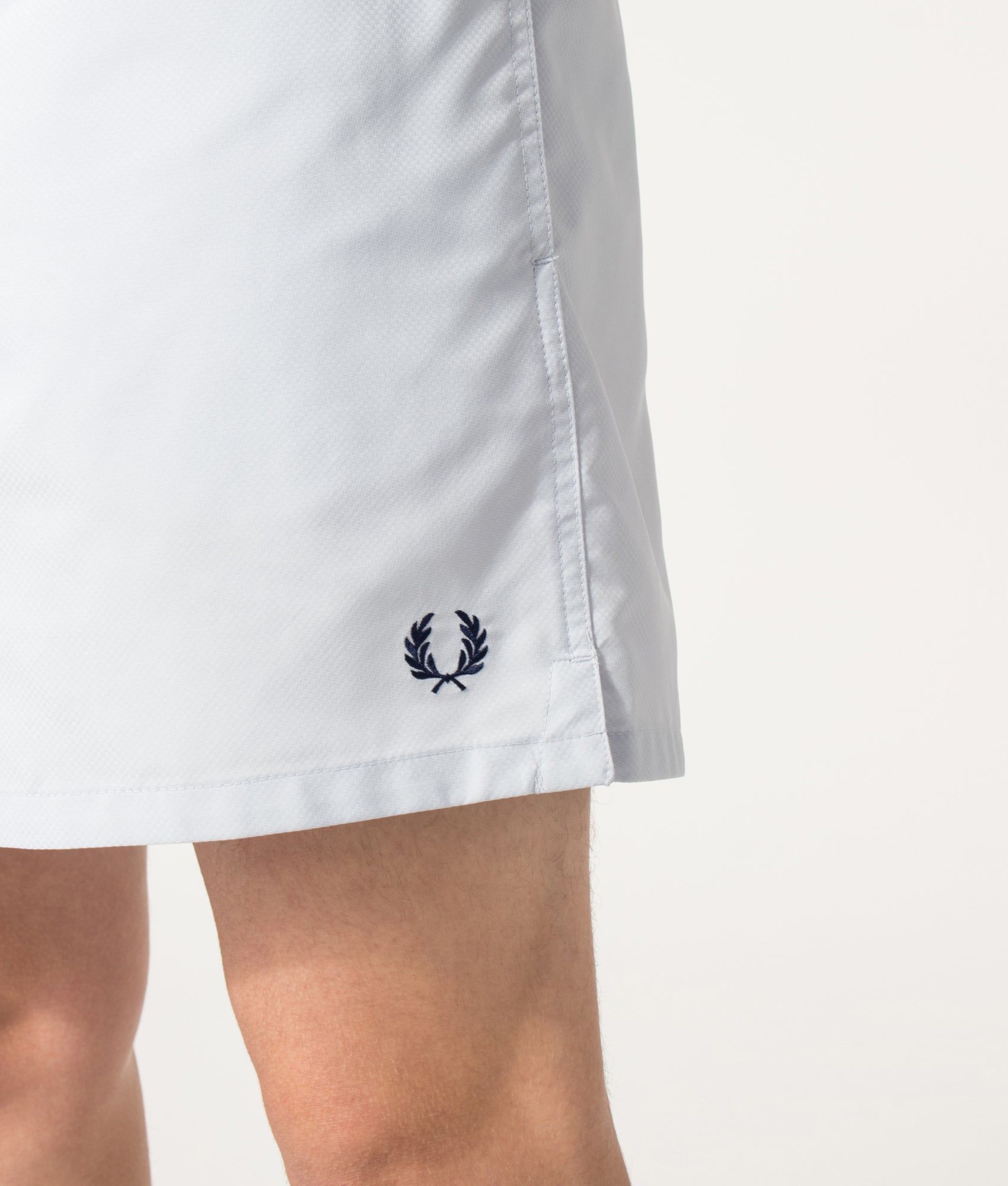 Fred Perry Swimshorts in Dusky blue at EQVVS Menswear. Detail shot.