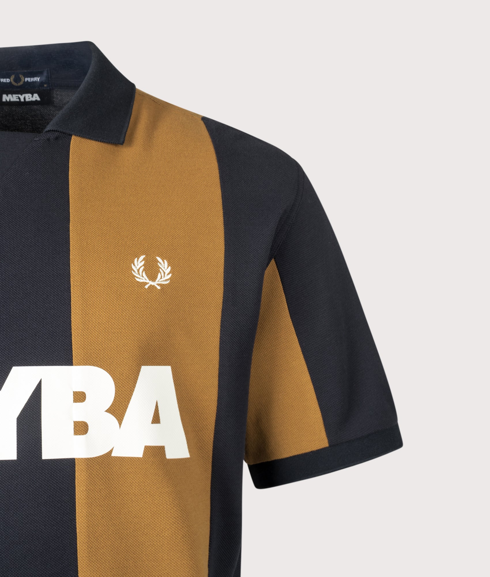 Meyba Cut And Sew Polo Shirt in Navy by Fred Perry. Shot by EQVVS. Logo detail shot.