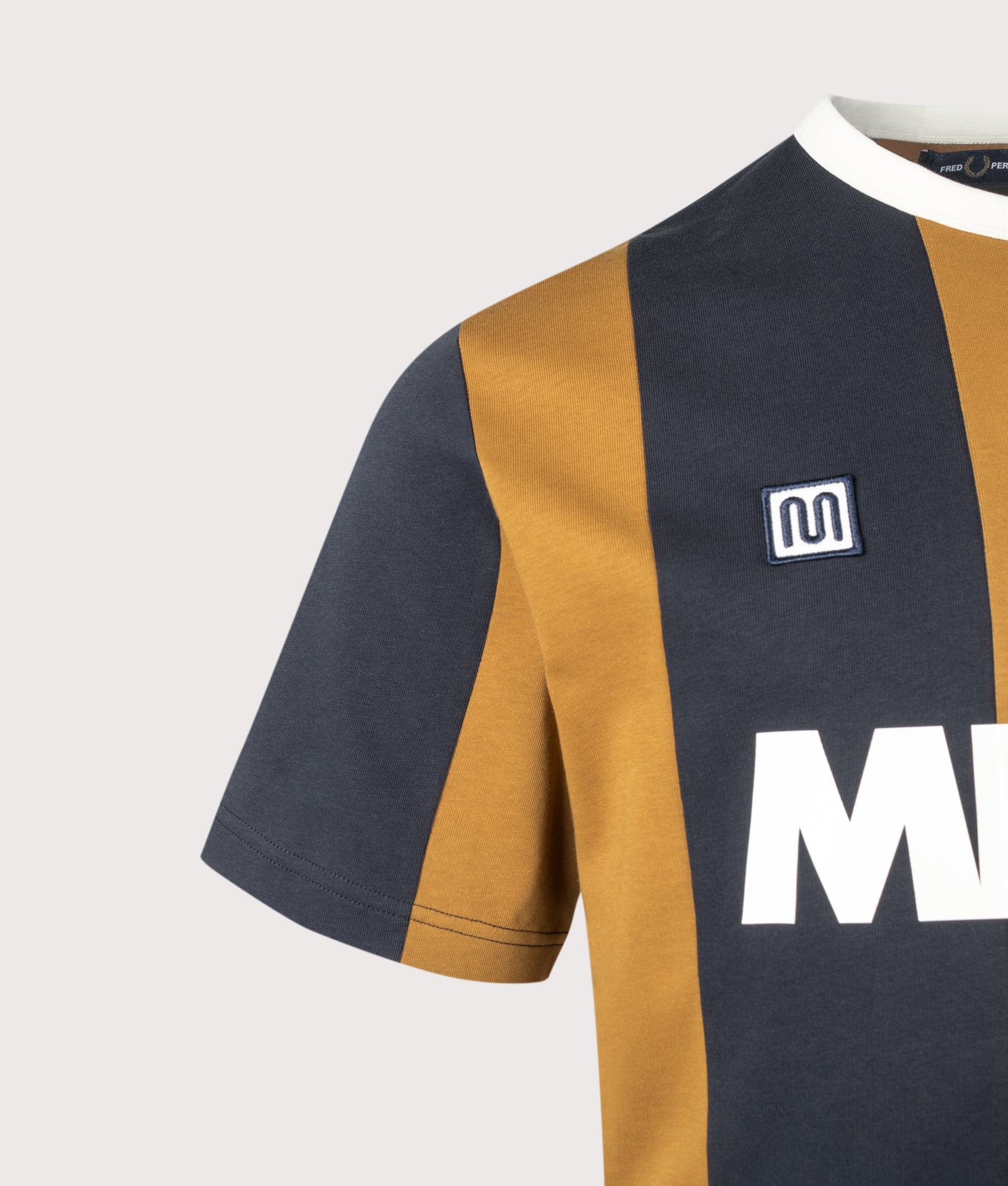 Meyba Cut And Sew T-Shirt in Dark Caramel by Fred Perry. Shot by EQVVS. Detail shot.