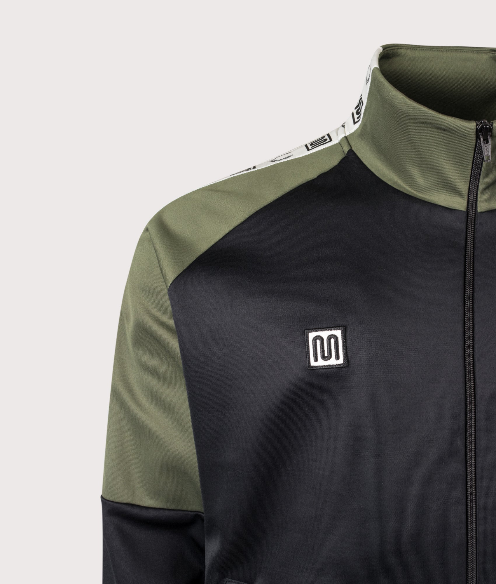 Meyba Taped Raglan Track Jacket in Black by Fred Perry. Shot by EQVVS. Detail shot.