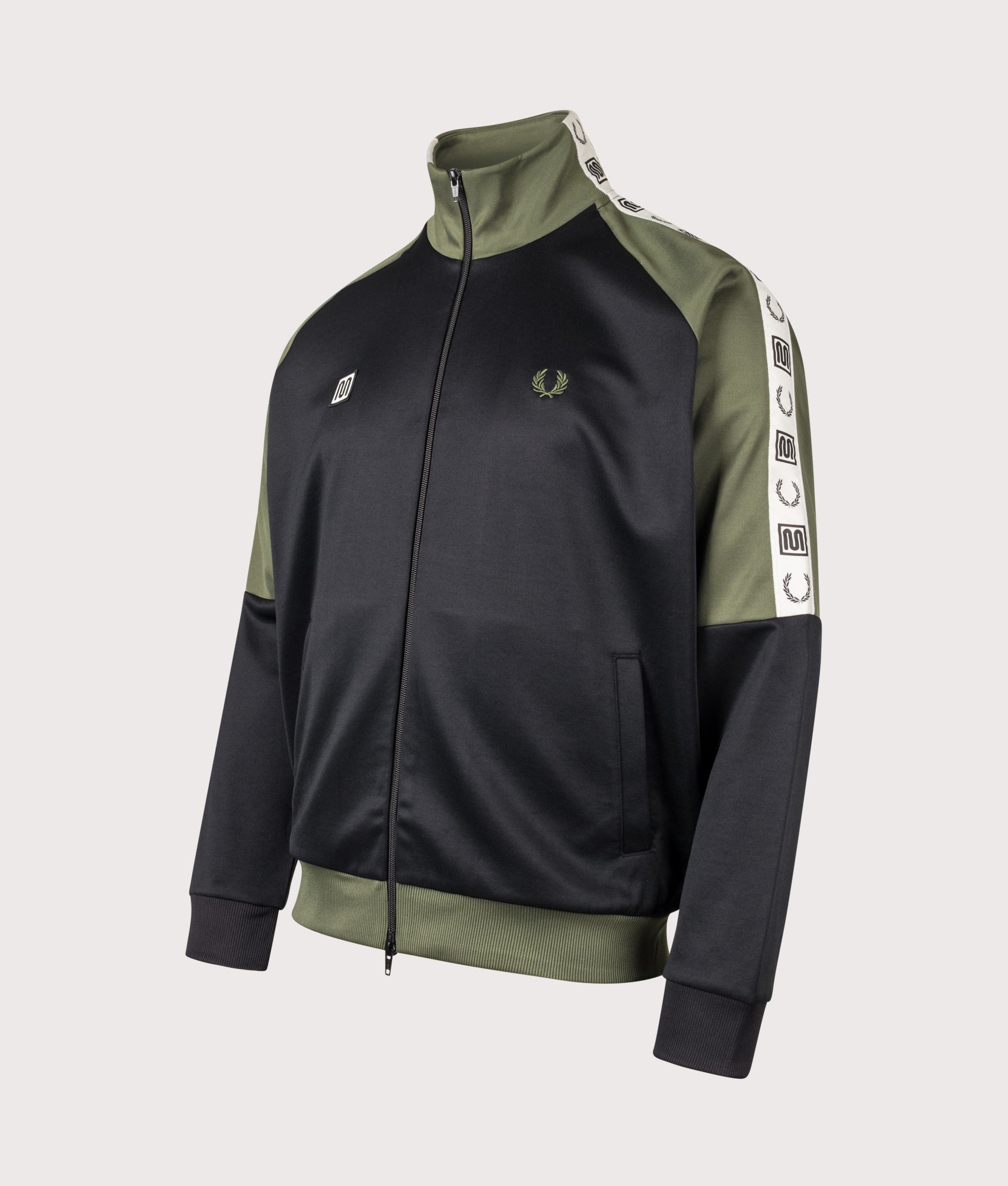 Meyba Taped Raglan Track Jacket in Black by Fred Perry. Shot by EQVVS. Front angled shot.
