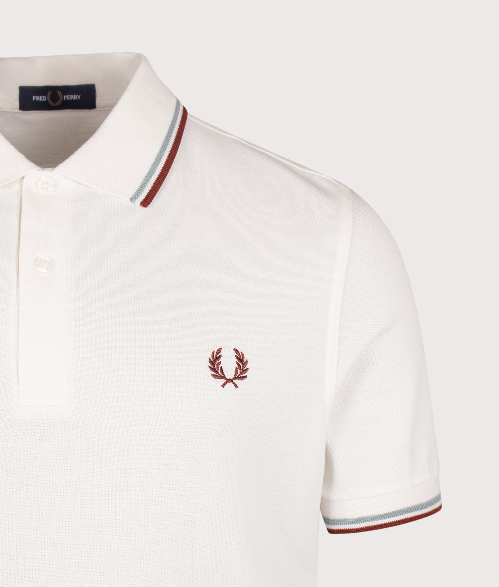 Fred Perry Twin Tipped Polo Shirt in  Snow White, Silver Blue and Brandy at EQVVS Menswear. Detail shot.