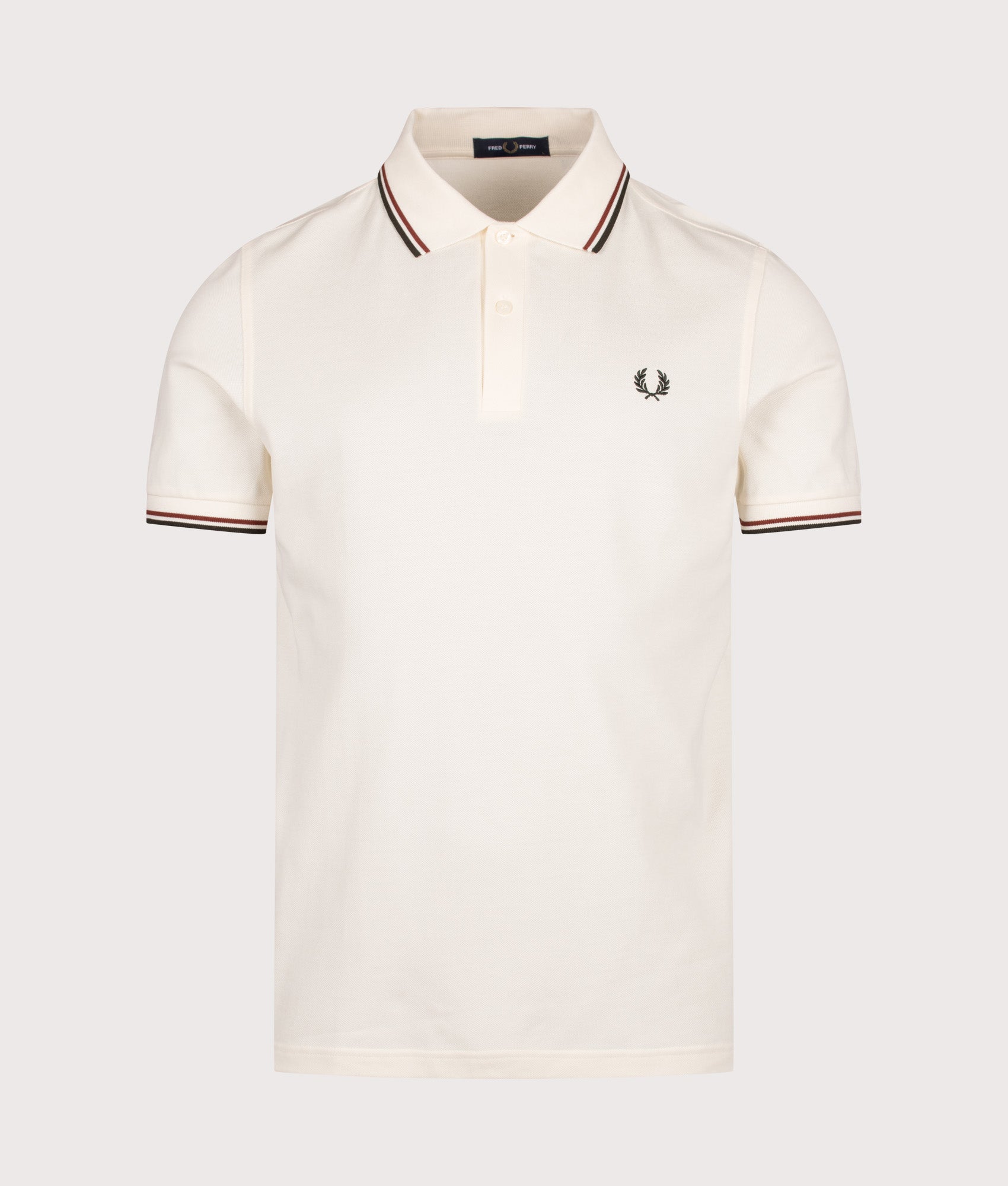 Fred Perry Twin Tipped Polo Shirt in Ecru, Brandy and Night Green at EQVVS Menswear. Front shot.
