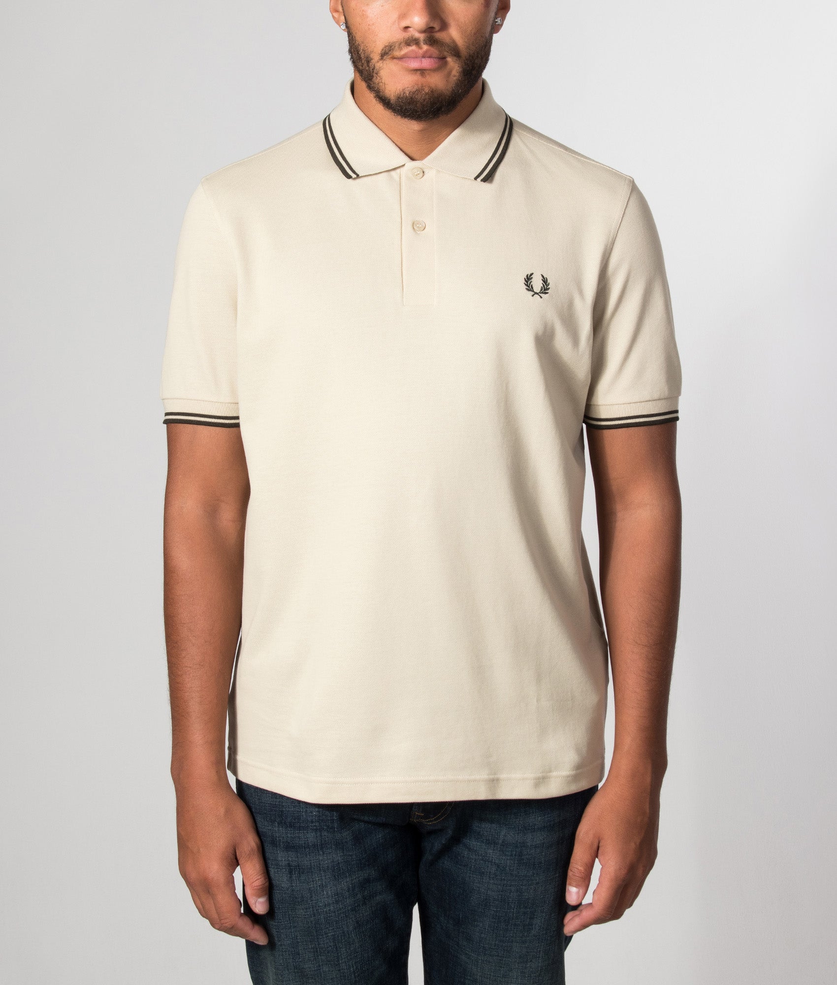 Fred Perry Twin Tipped Polo Shirt in Oatmeal and Night Green at EQVVS Menswear. Model front shot.