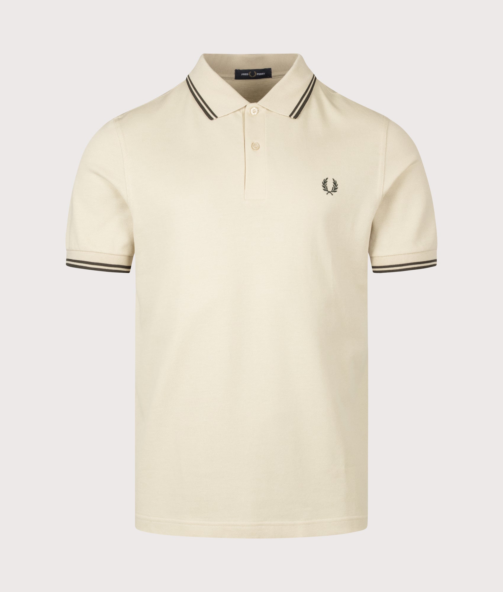 Fred Perry Twin Tipped Polo Shirt in Oatmeal and Night Green at EQVVS Menswear. Front shot.