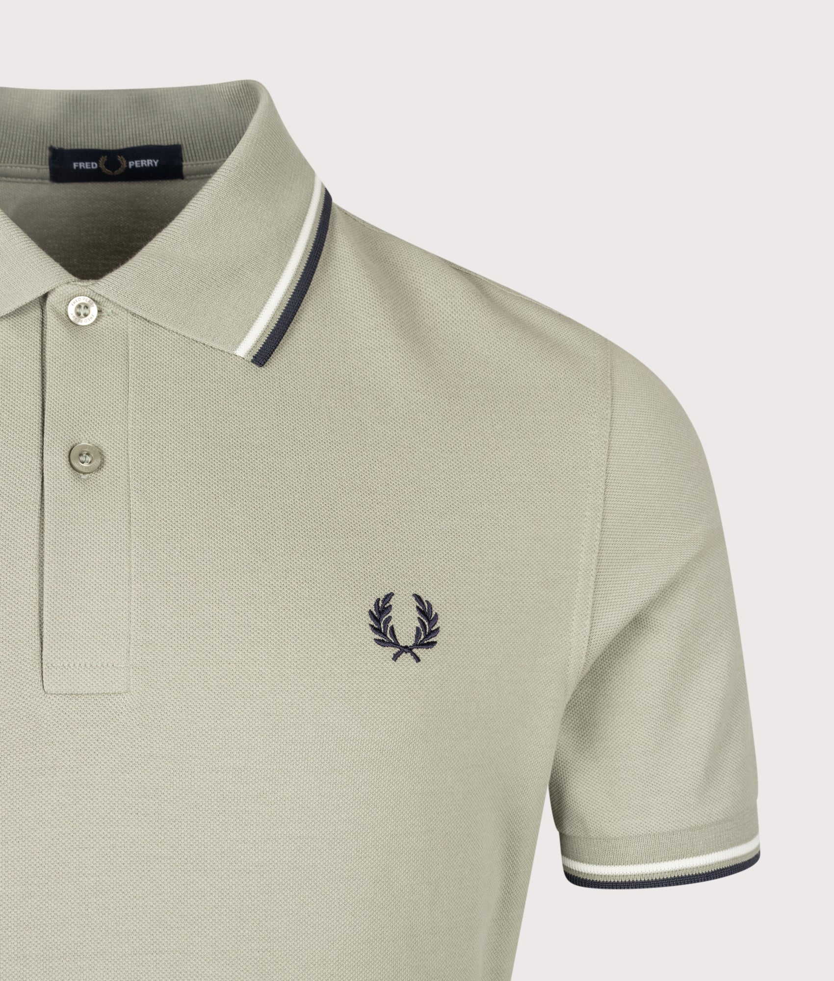 Fred Perry Twin Tipped Polo Shirt in Seagrass, Ecru and Dark Airforce at EQVVS Menswear. Detail shot.