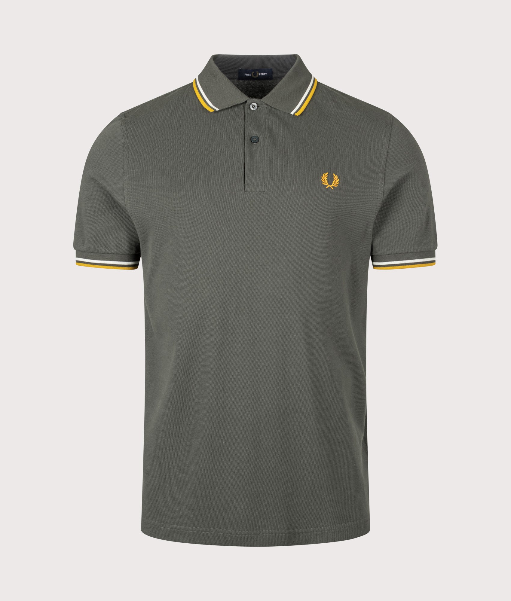 Fred Perry Twin Tipped Polo Shirt in Field Green, Ecru and Golden at EQVVS Menswear. Front shot.