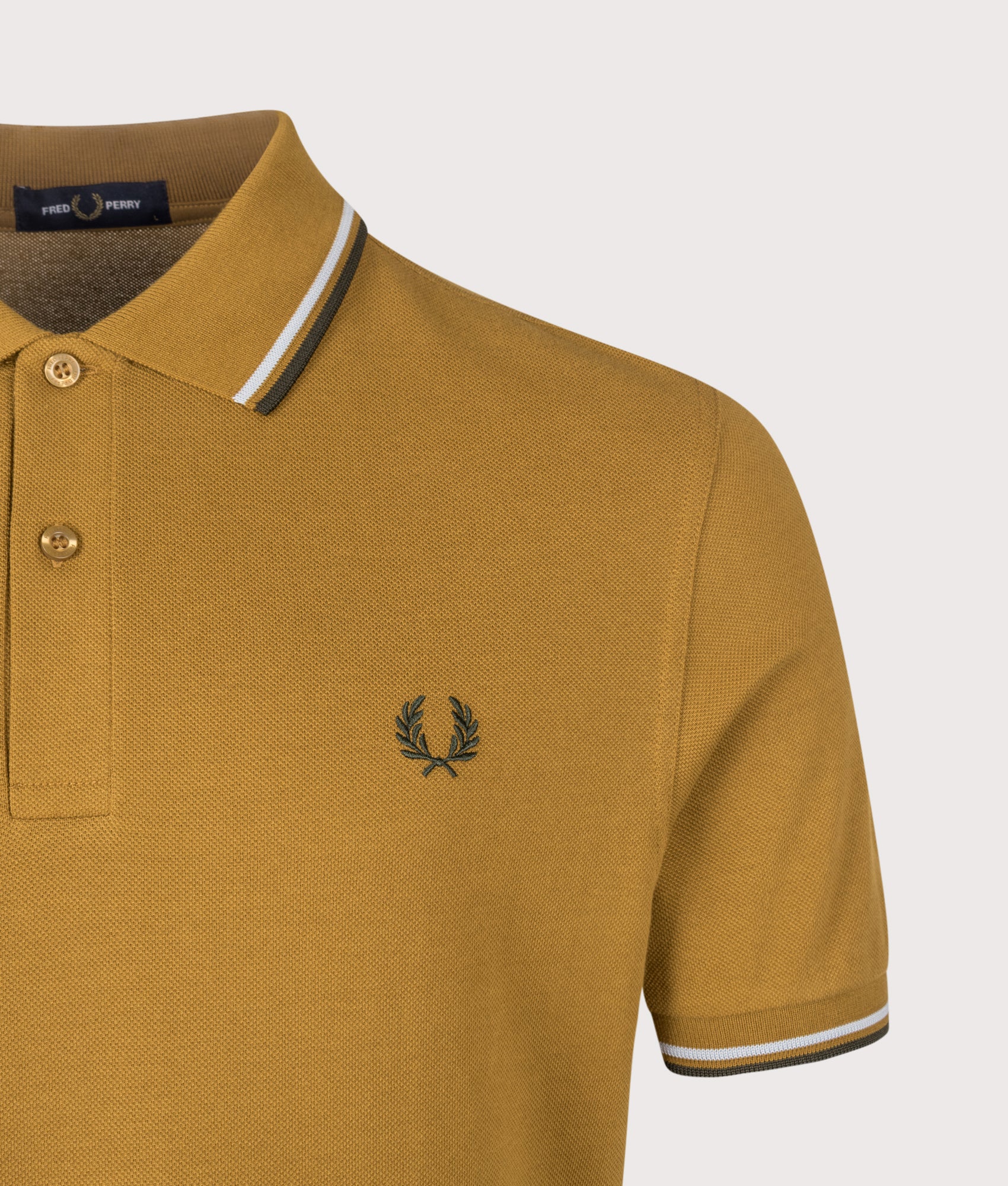 Fred Perry Twin Tipped Polo Shirt in Dark Caramel, Dusky Blue and Night Green at EQVVS Menswear. Detail shot.