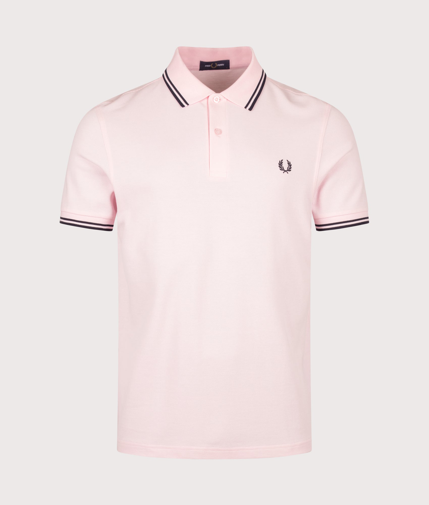 Fred Perry Twin Tipped Polo Shirt in Iced Pink and Navy at EQVVS Menswear. Front shot.