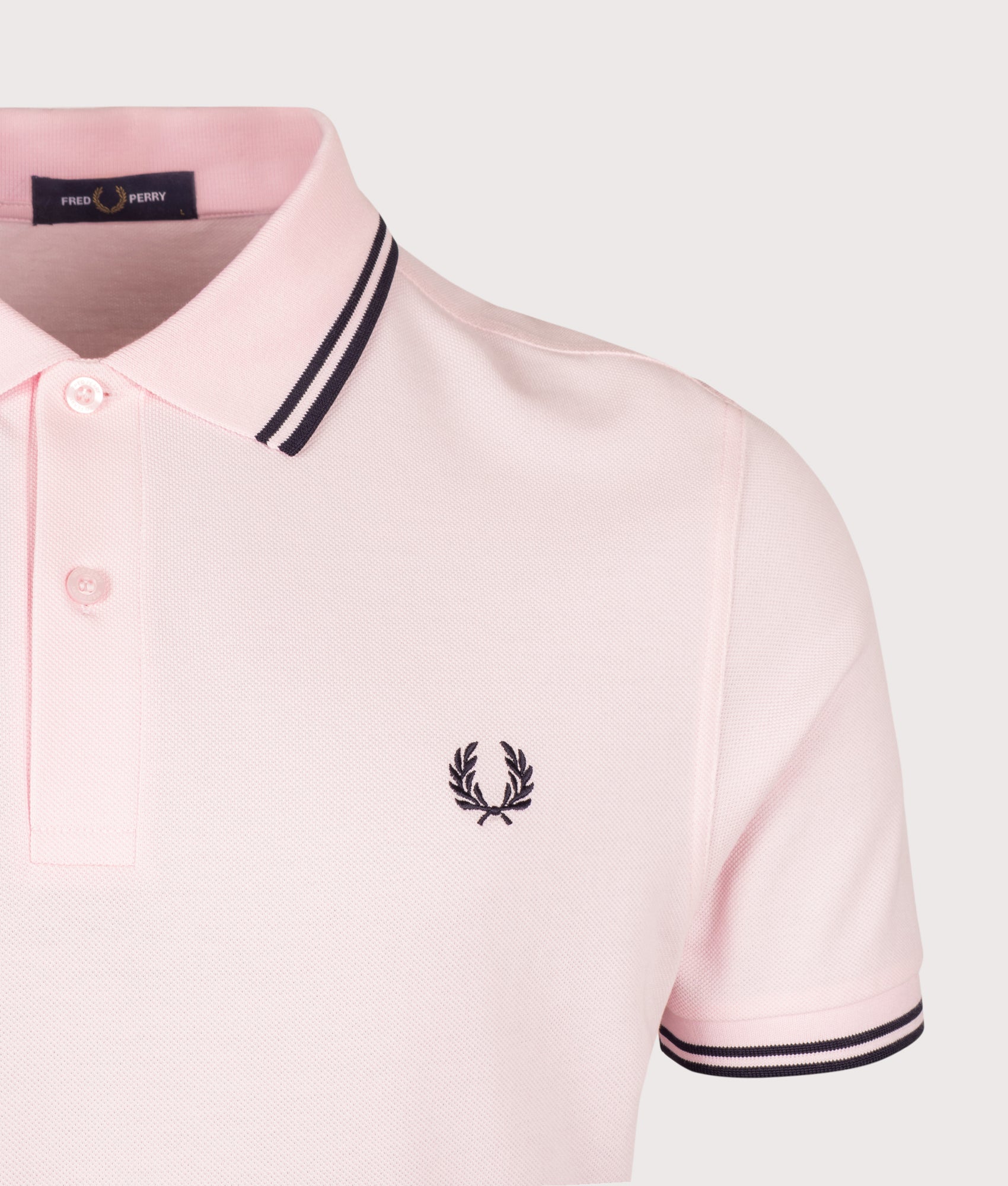 Fred Perry Twin Tipped Polo Shirt in Iced Pink and Navy at EQVVS Menswear. Detail shot.